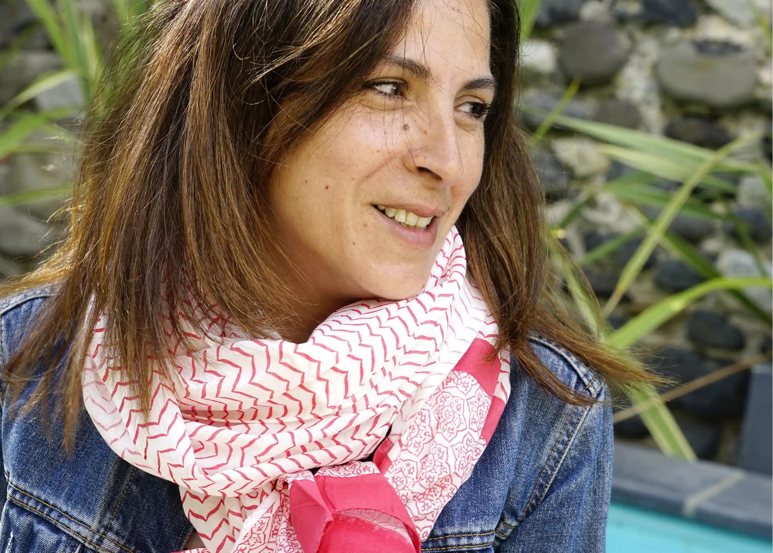 Woman wearing a red cotton pareo scarf wrapped around her body