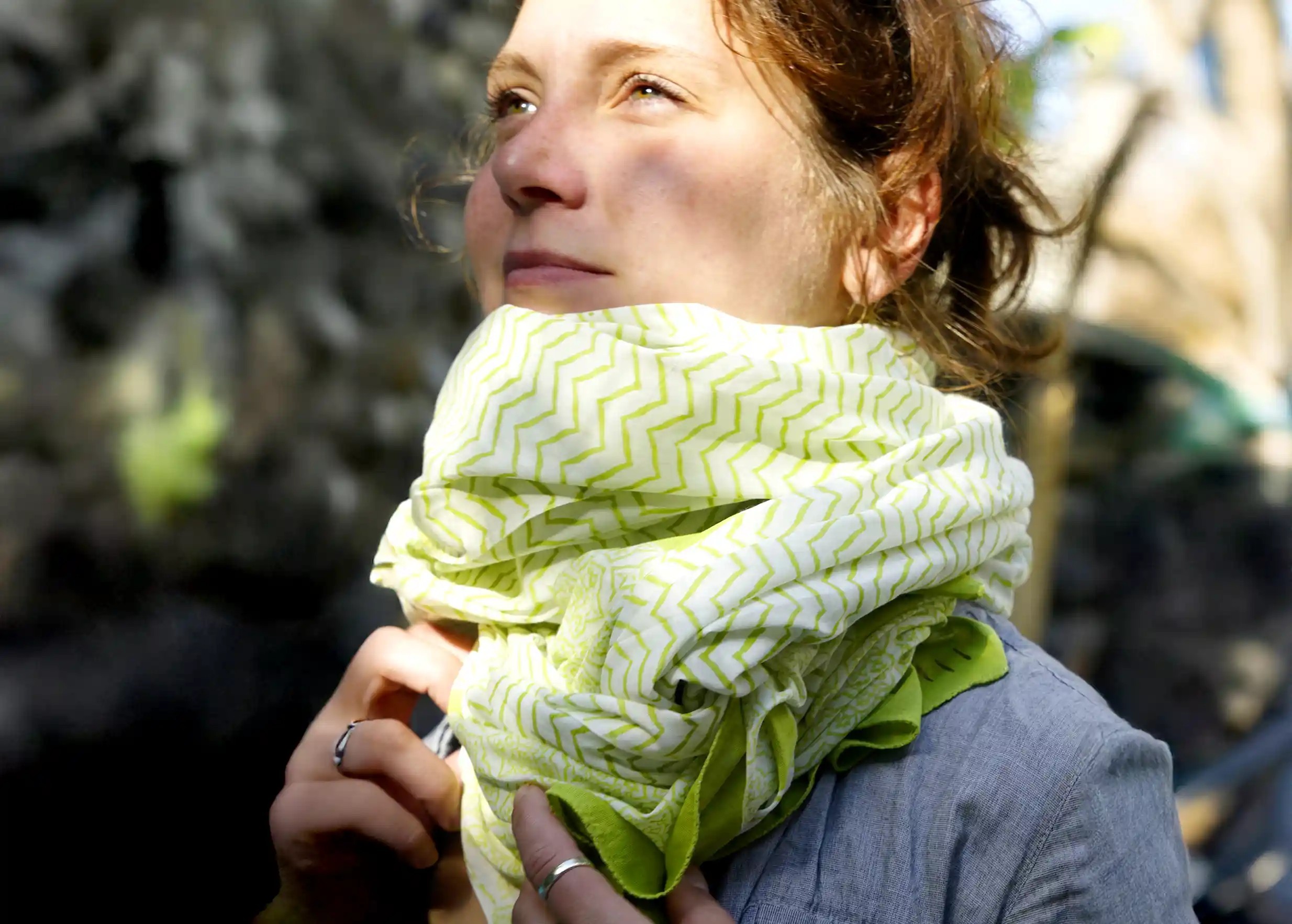 Woman wearing a red cotton sarong wrapped around her neck