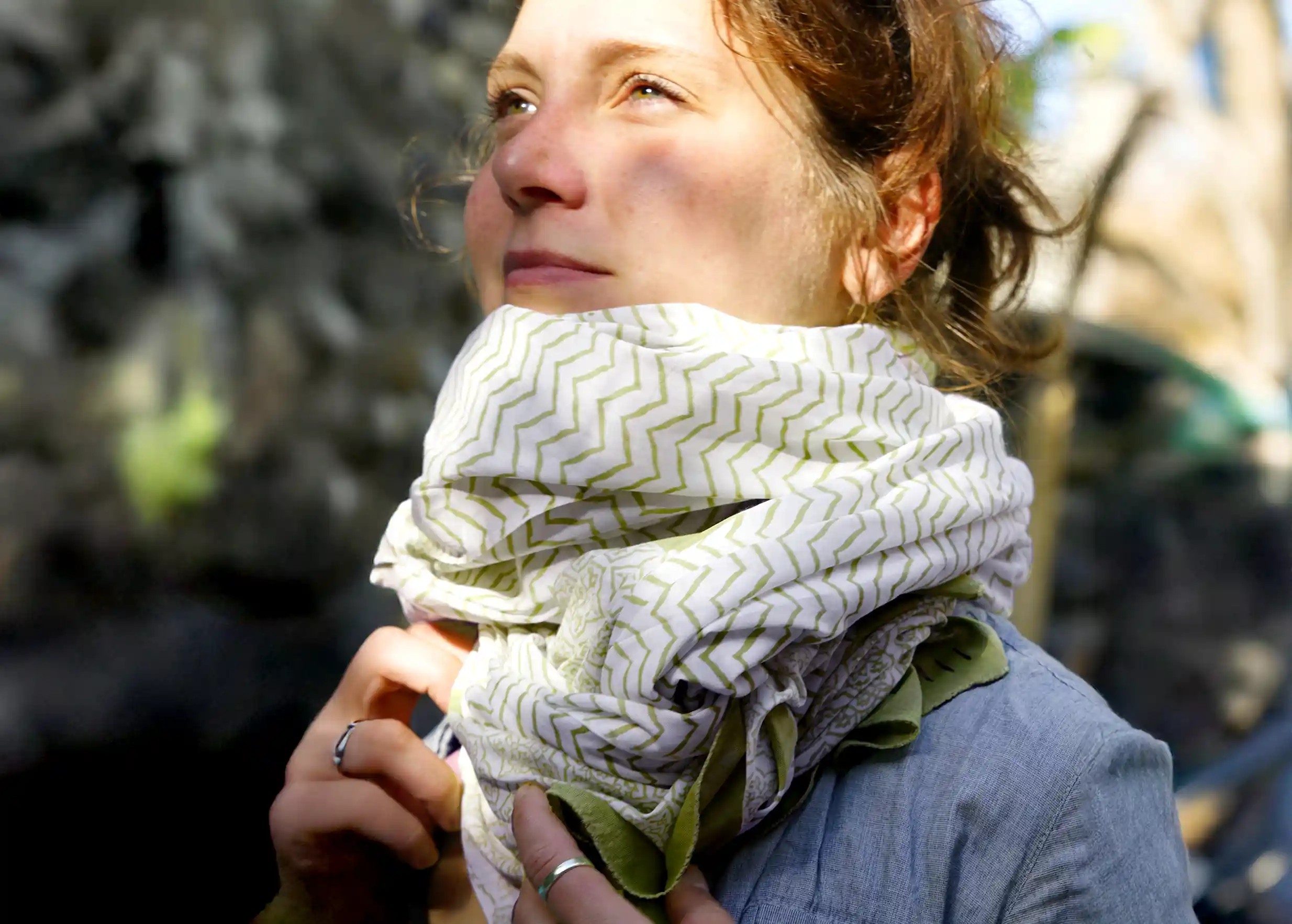 Woman wearing a red cotton cheche sarong wrapped around her neck