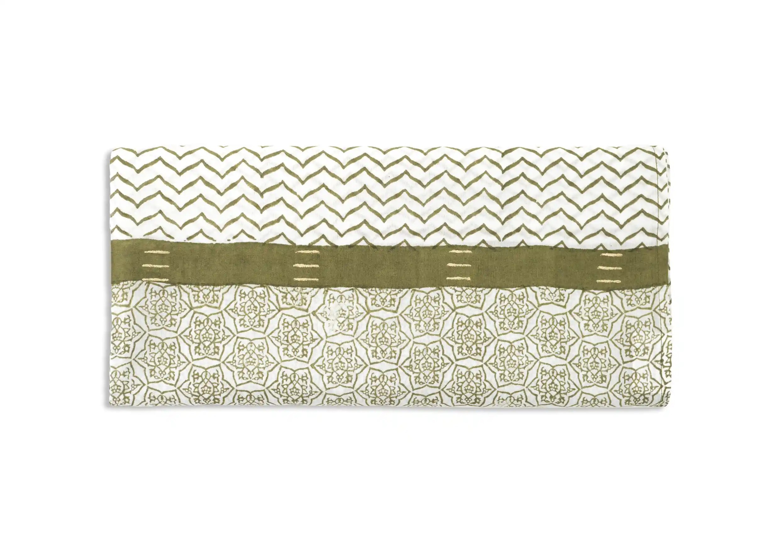 Focus on the zigzag patterns of the olive green Karawan pareo-scarf