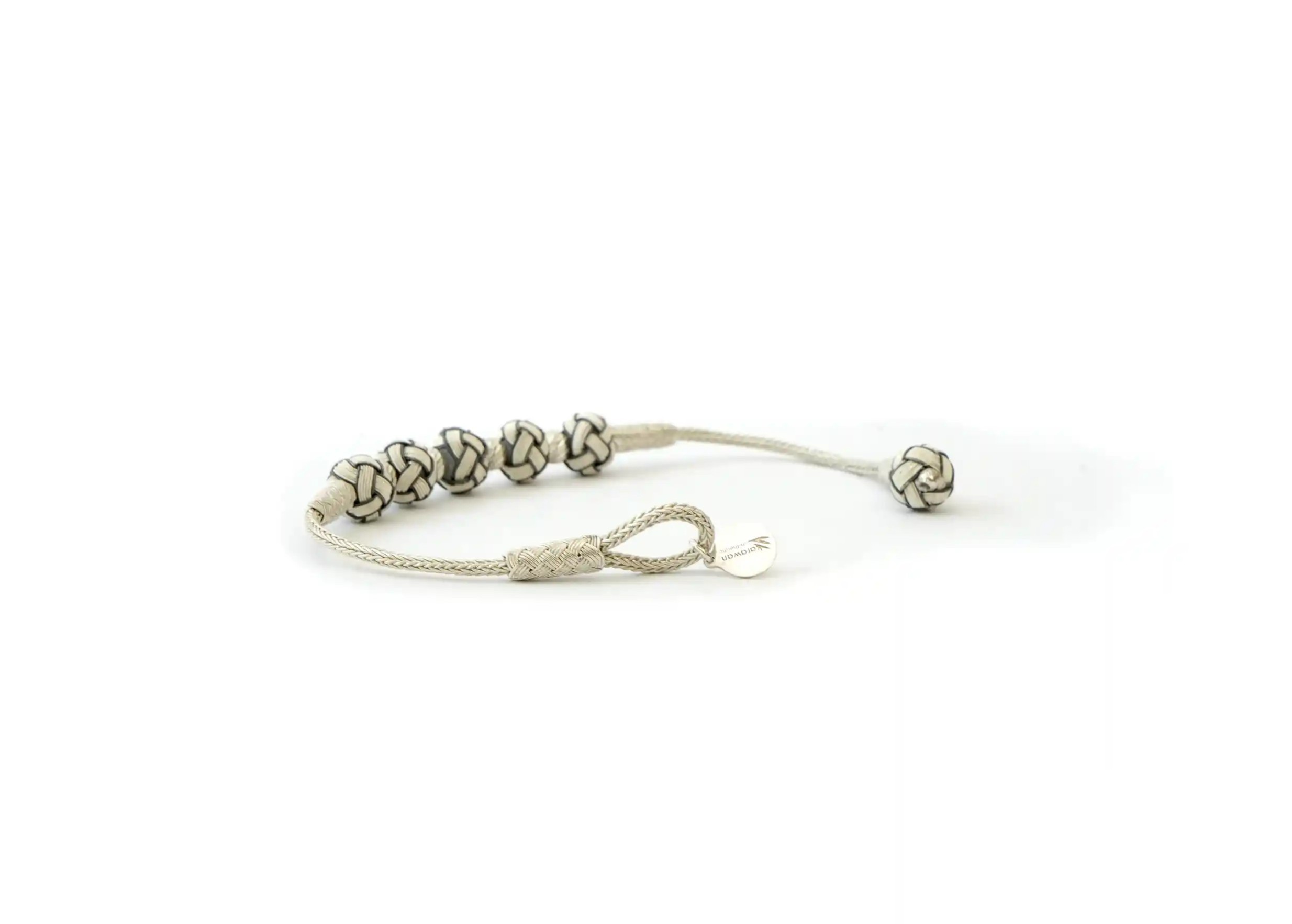 Silver bracelet with 5 white knots, by Karawan, photo on white background
