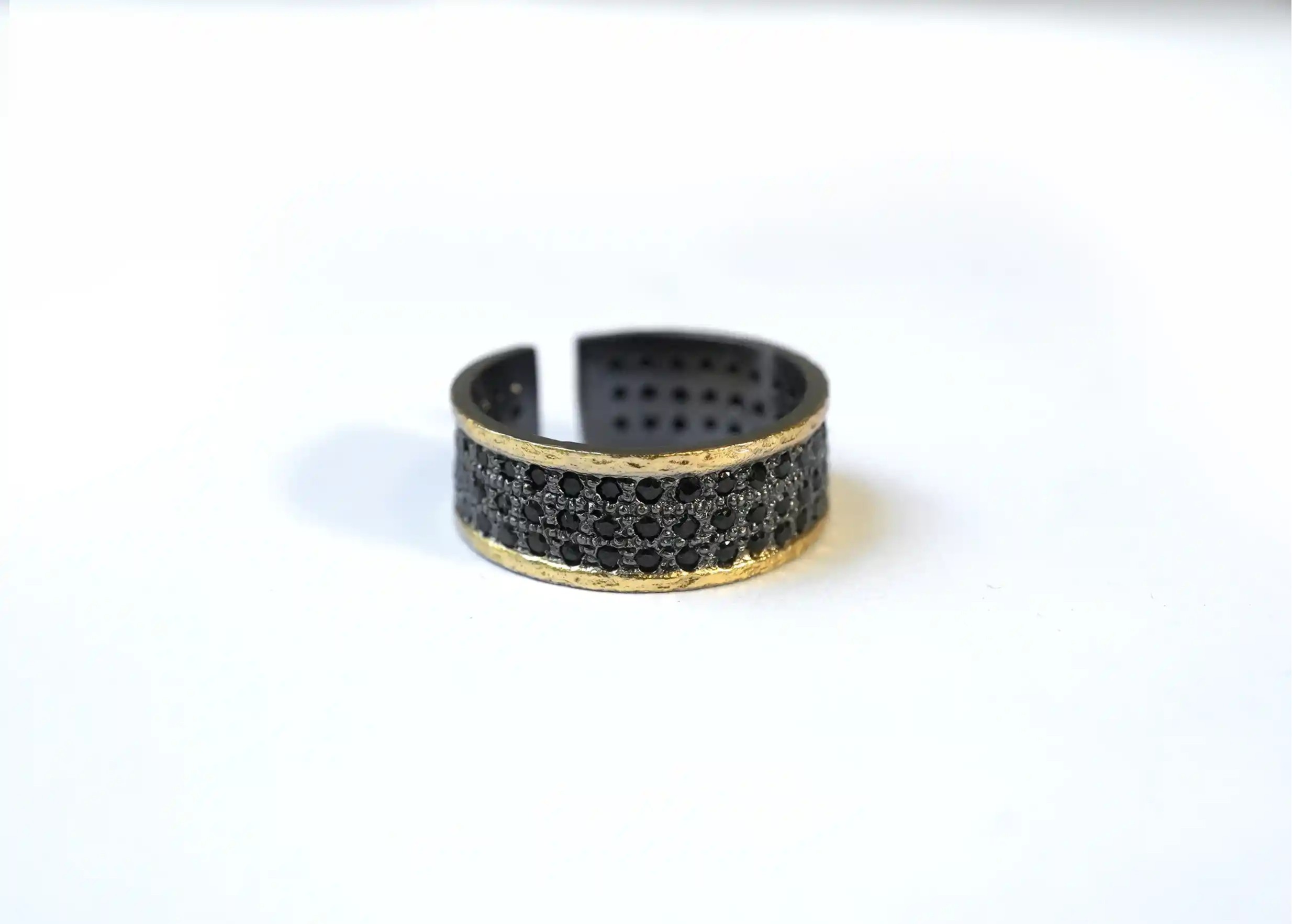 Adjustable brass and zirconium ring Dawn of Time collection on a white background