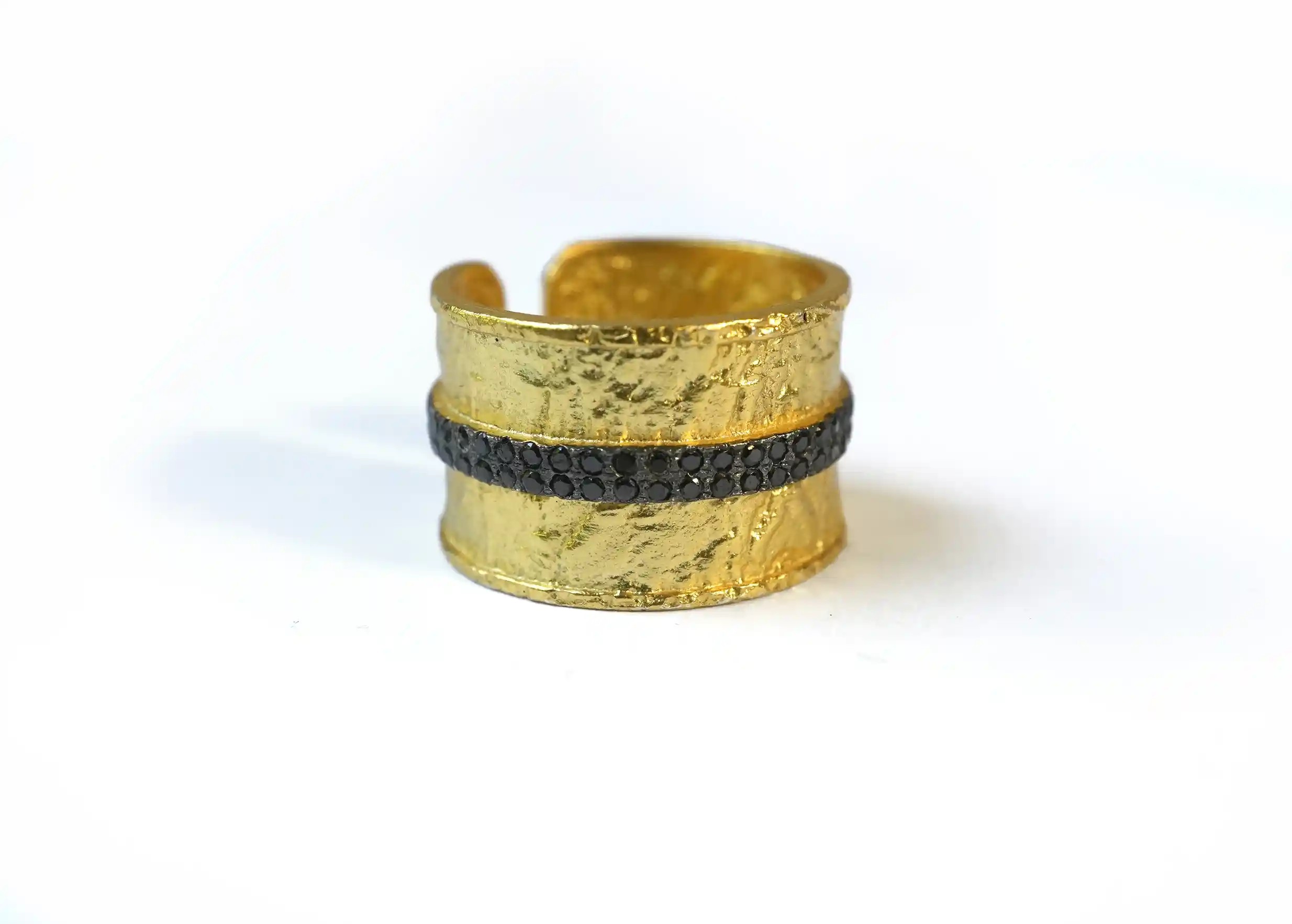 Adjustable gilded-plated brass ring “shiny night” from the Nuit des Temps collection, on a white background