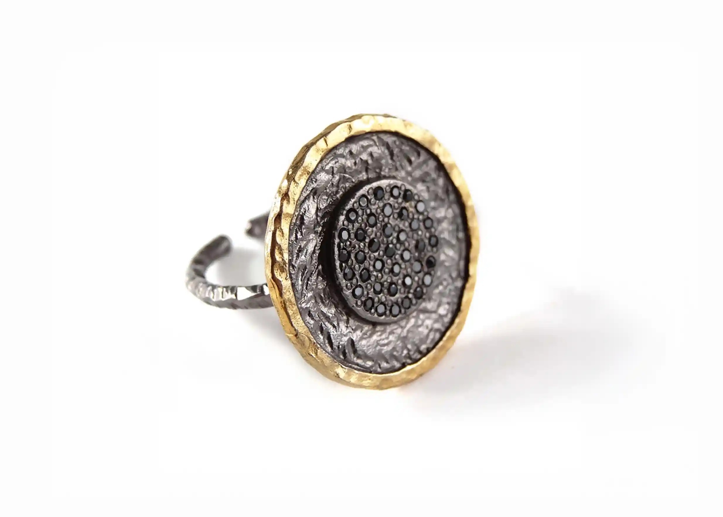 Brass ring from the Nuit des Temps collection, photo taken against a white background