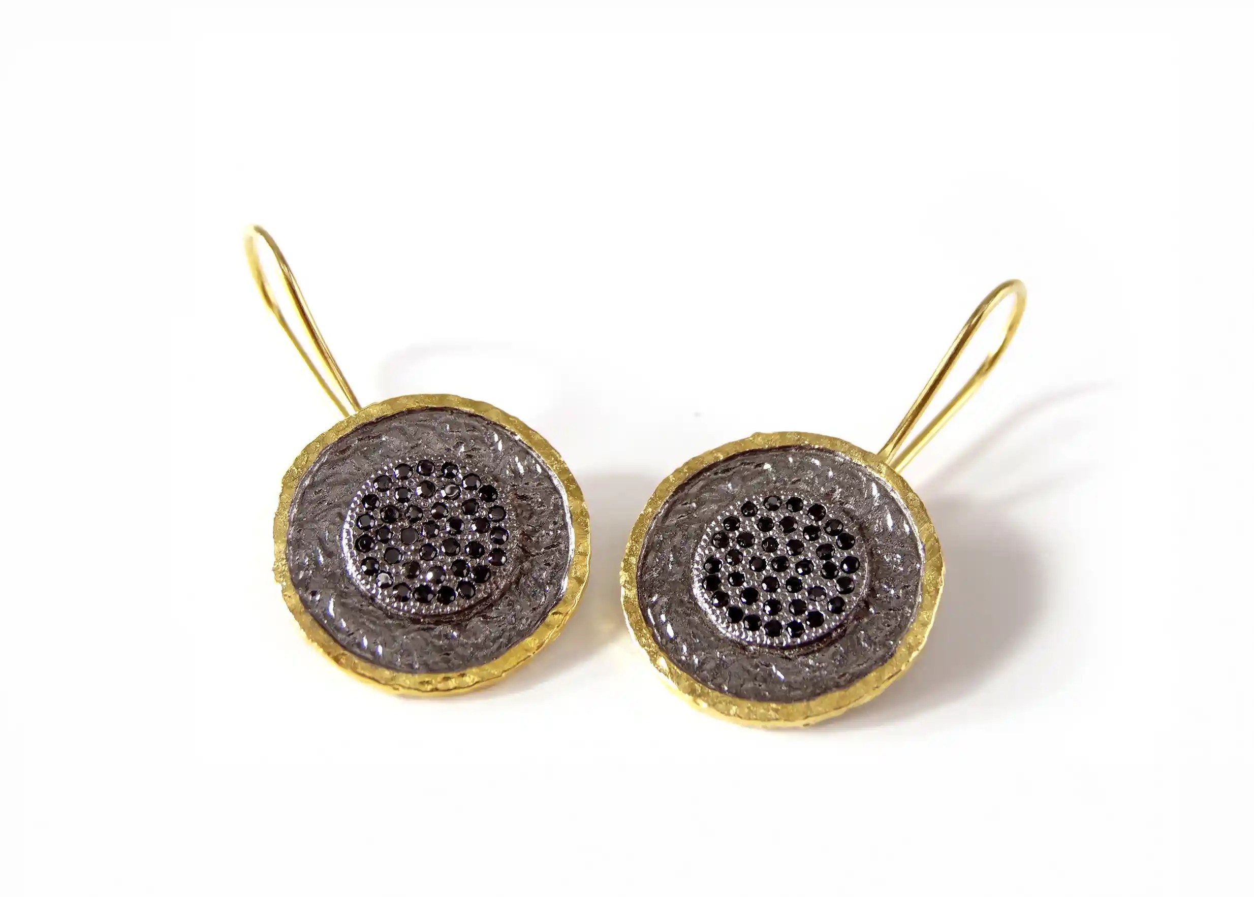 Brass and zirconium earrings from the Nuit des Temps collection, gold and black colour, photo taken in packshot