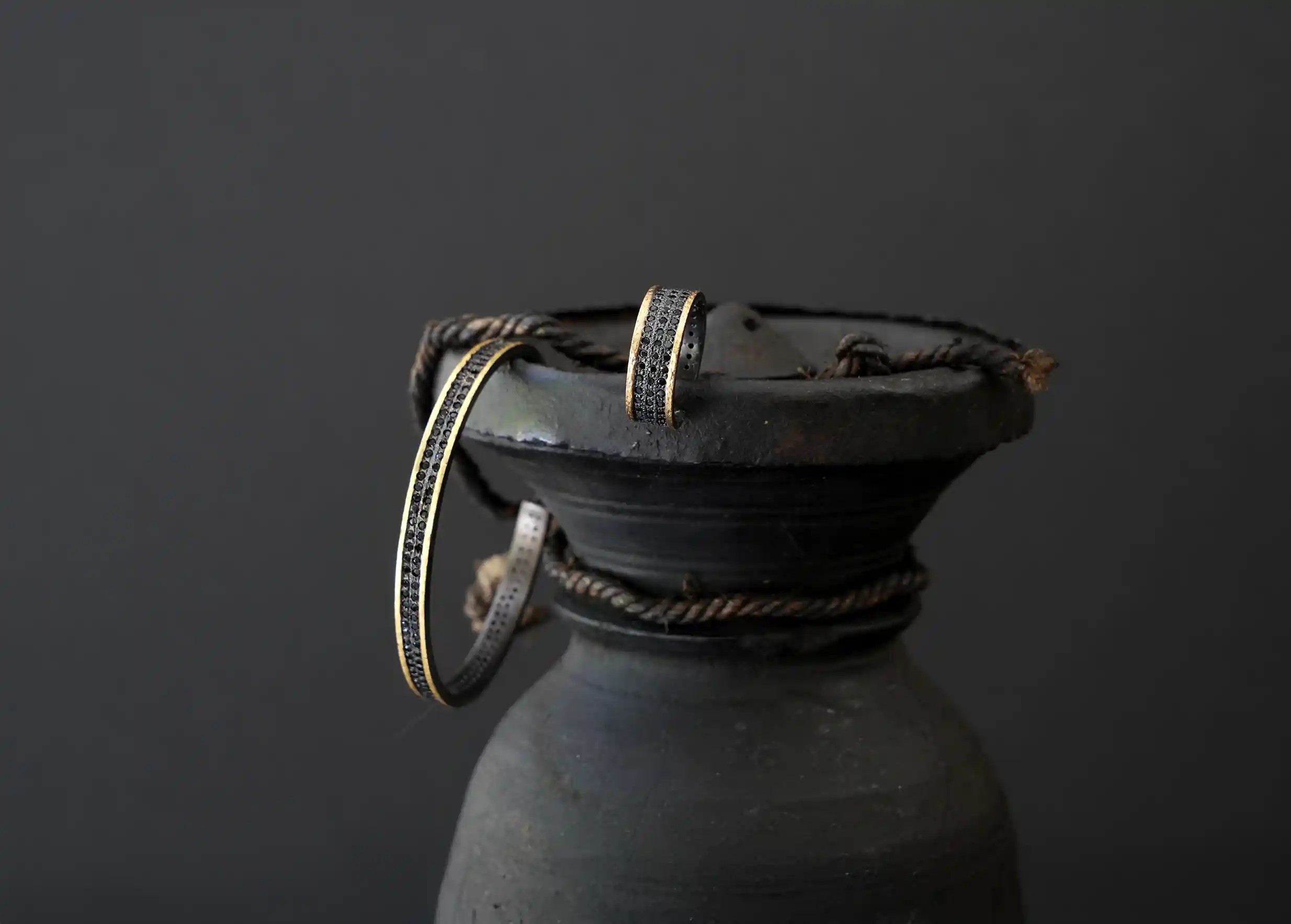 Jewellery set from the Dawn of Time collection, on a Yak butter pot