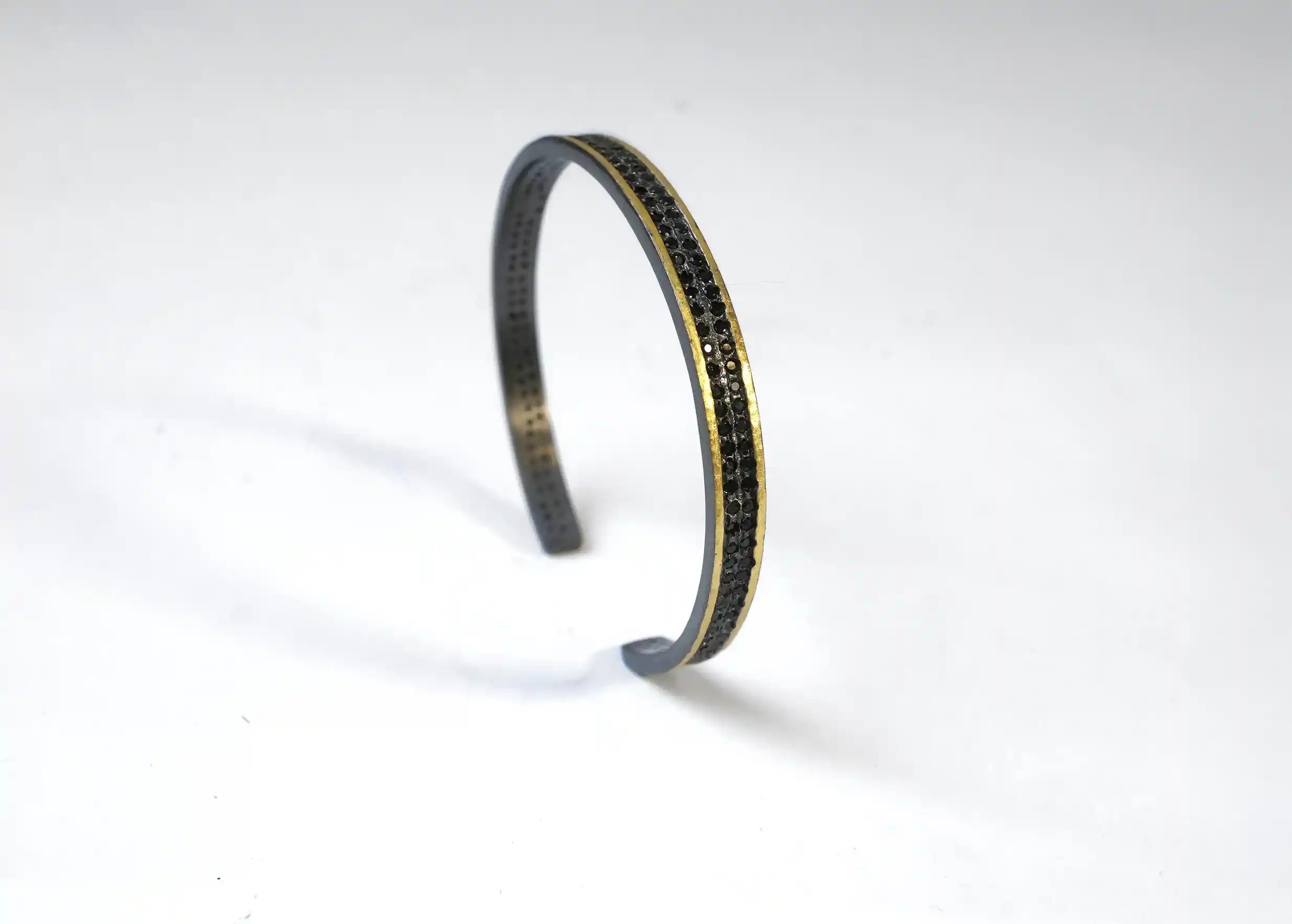 Adjustable bracelet in brass, oxidised brass and zirconium Nuit des Temps, on a white background