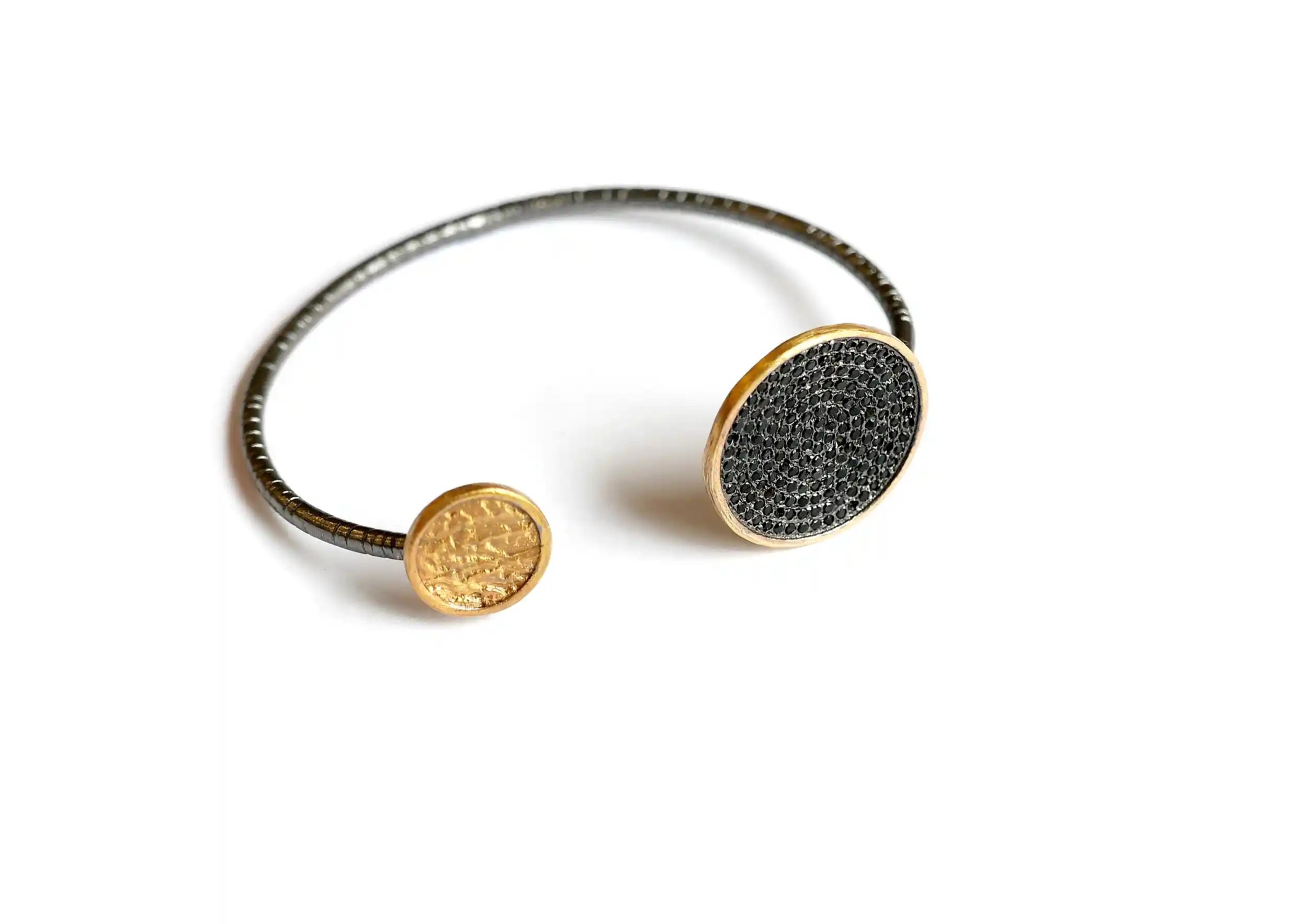 Handcrafted brass and zirconium bangle bracelet from the Dawn of Time collection, photo taken with a packhot.
