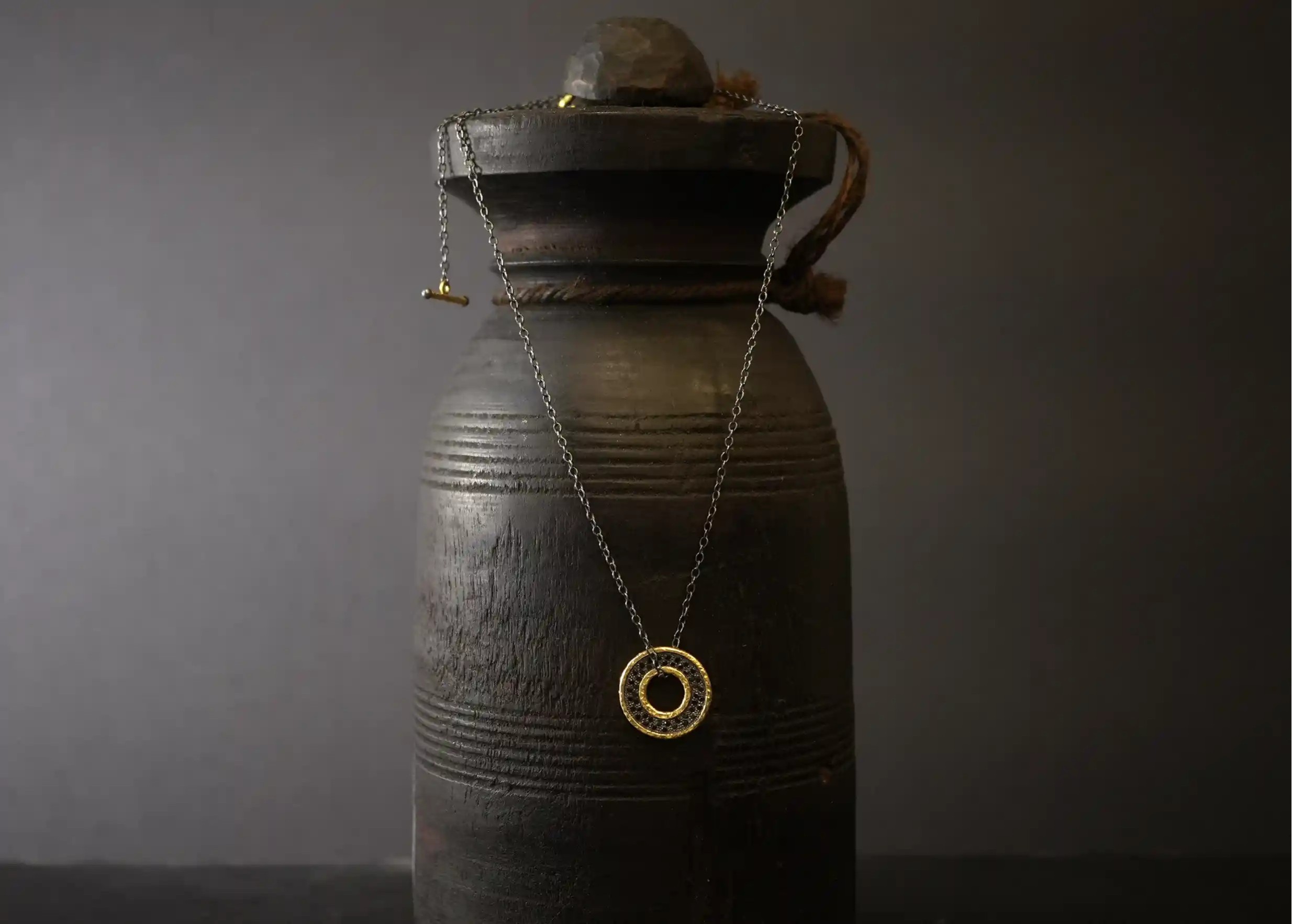 Gilded-plated Brass medallion necklace with chain and black zirconium inlays, by Karawan