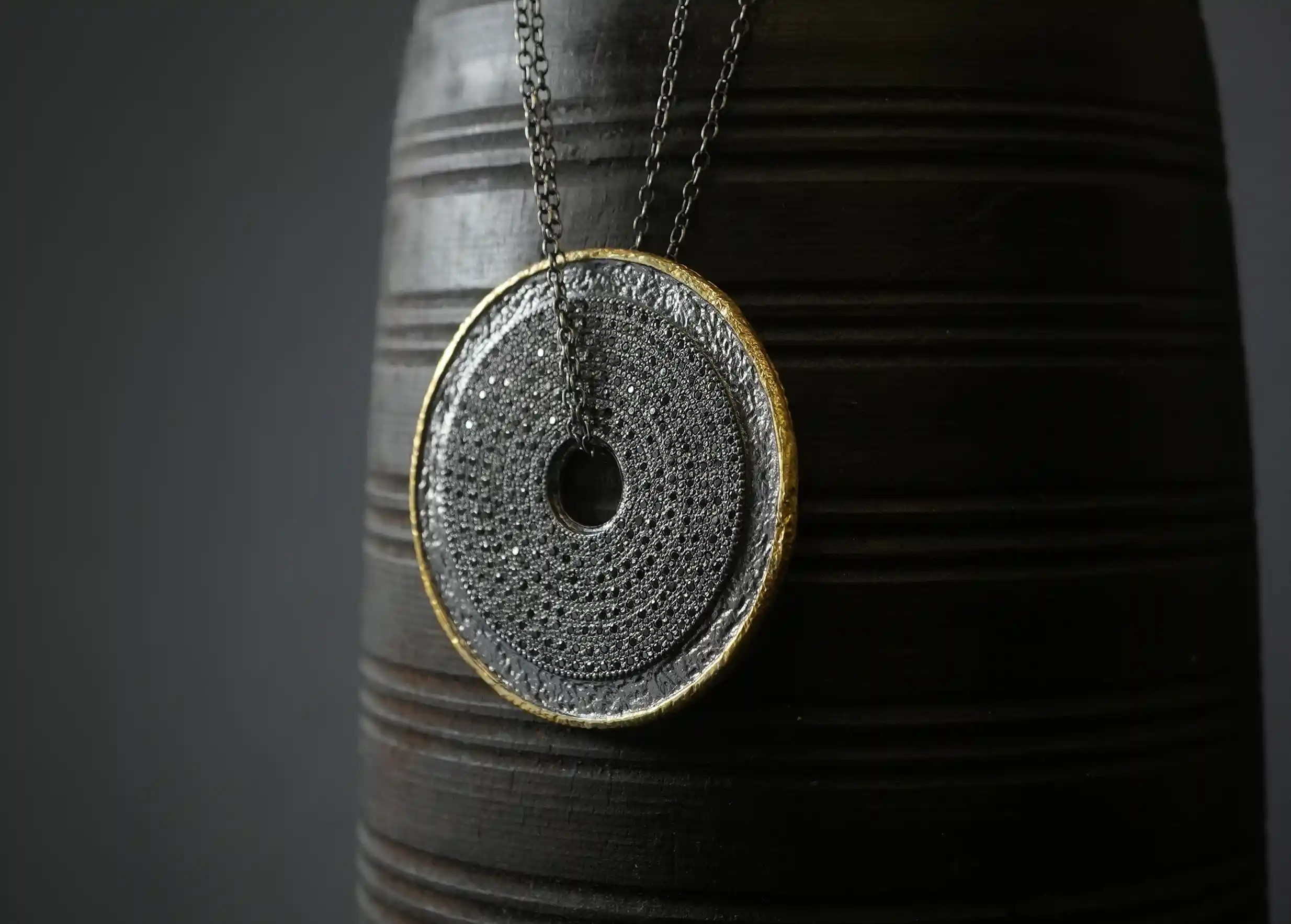 Focus on the brass and zirconium talisman necklace, with adjustable double chain and T-clasp