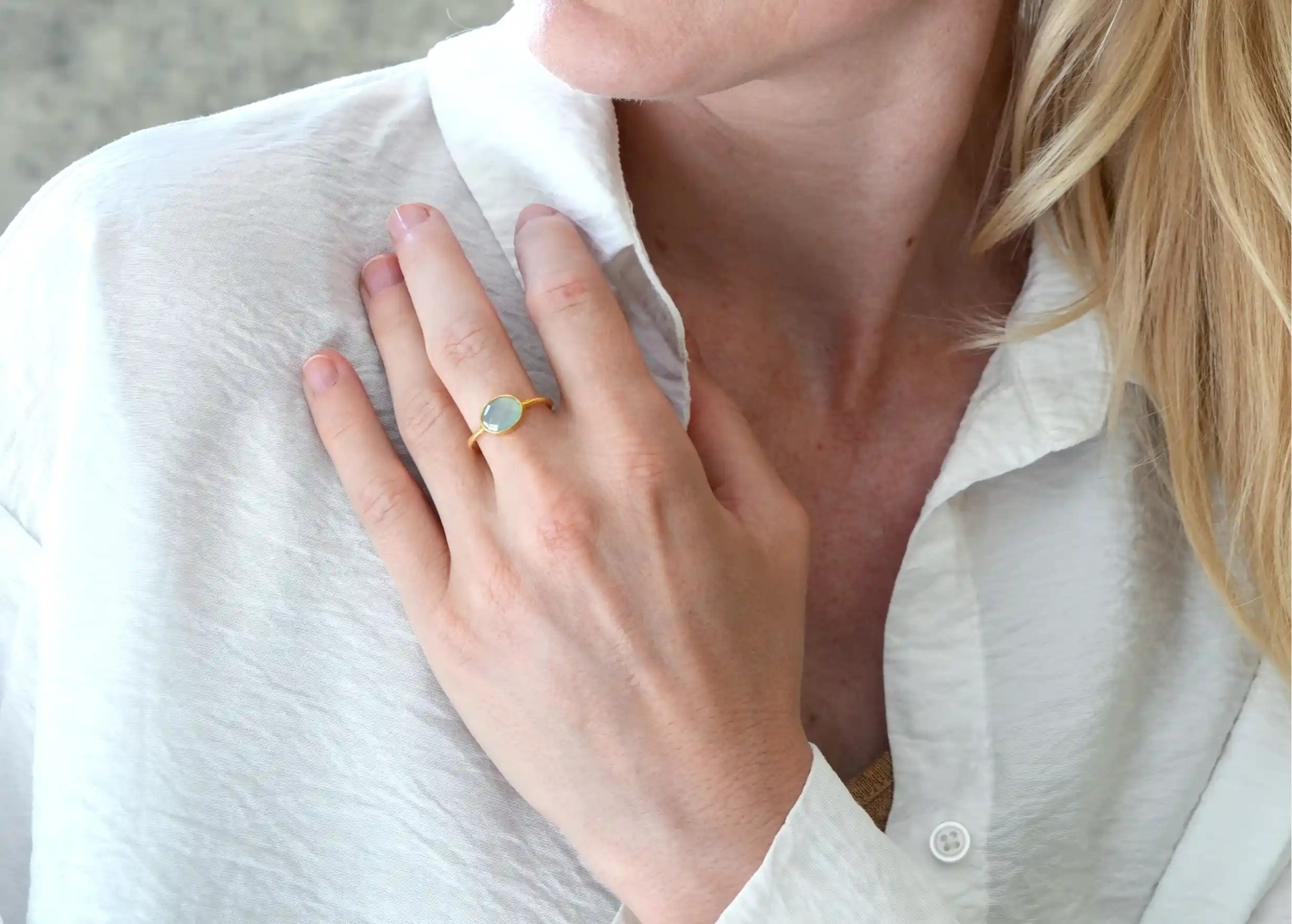 Gold-plated Drop ring, chalcedony worn by a woman indoors