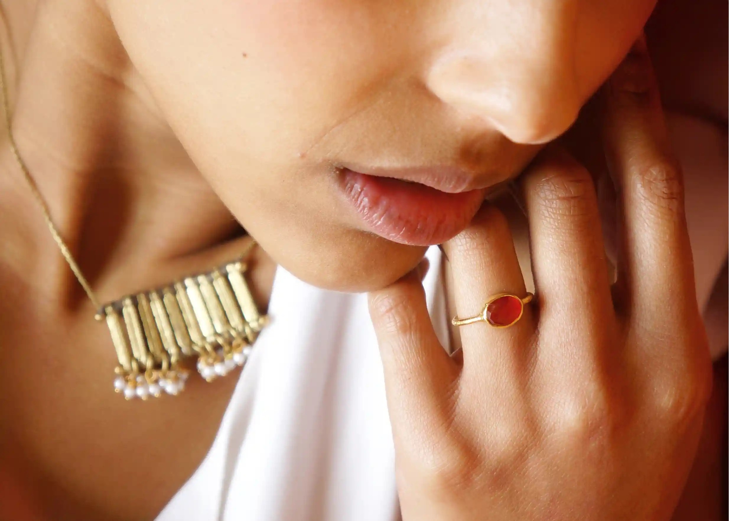 Jewellery set for women, including a gold-plated Drop ring with carnelian stone from the Karawan Authentic brand.