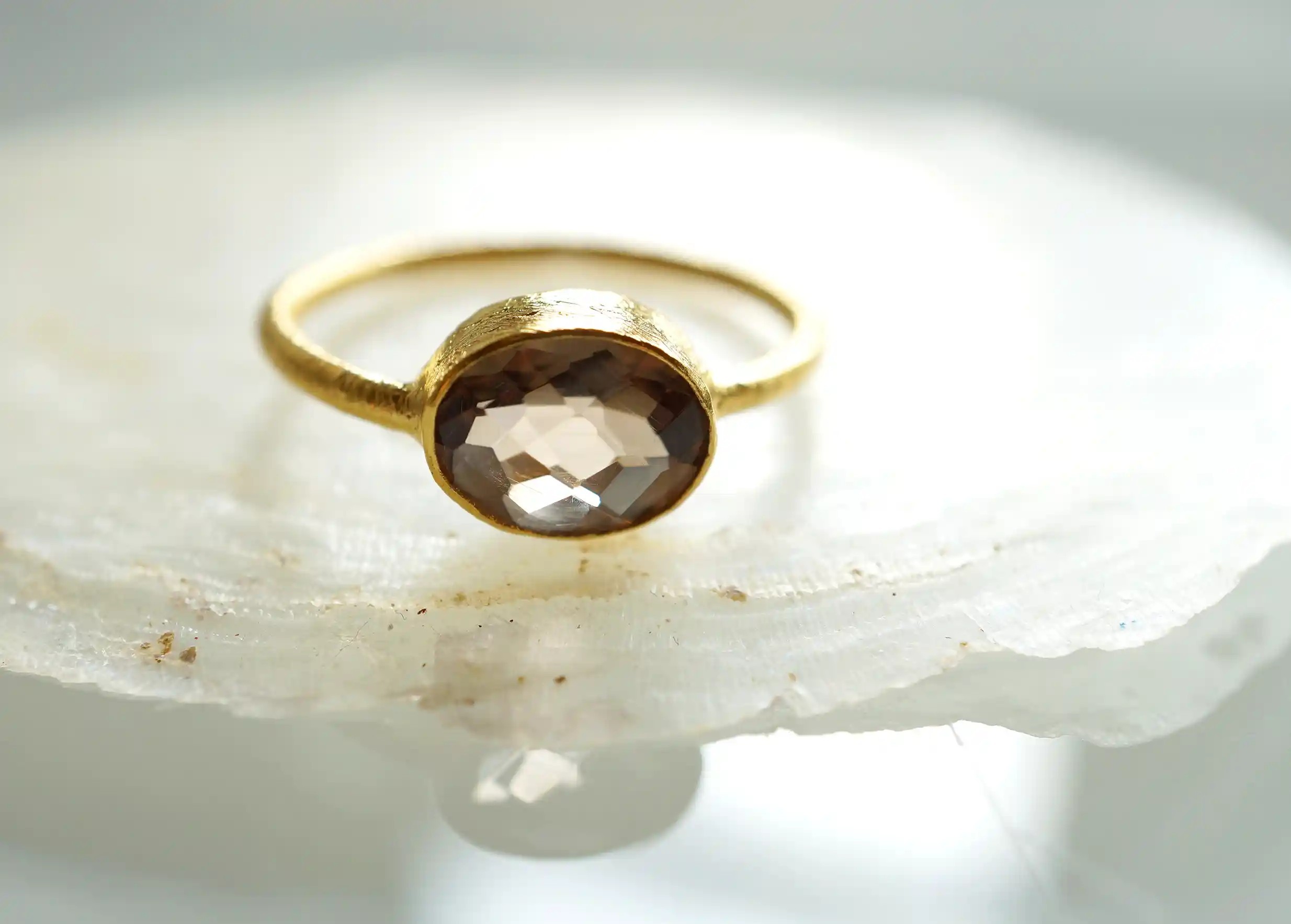 ‘Drop’ ring in gold with smoky quartz stone on the front, Yamuna collection