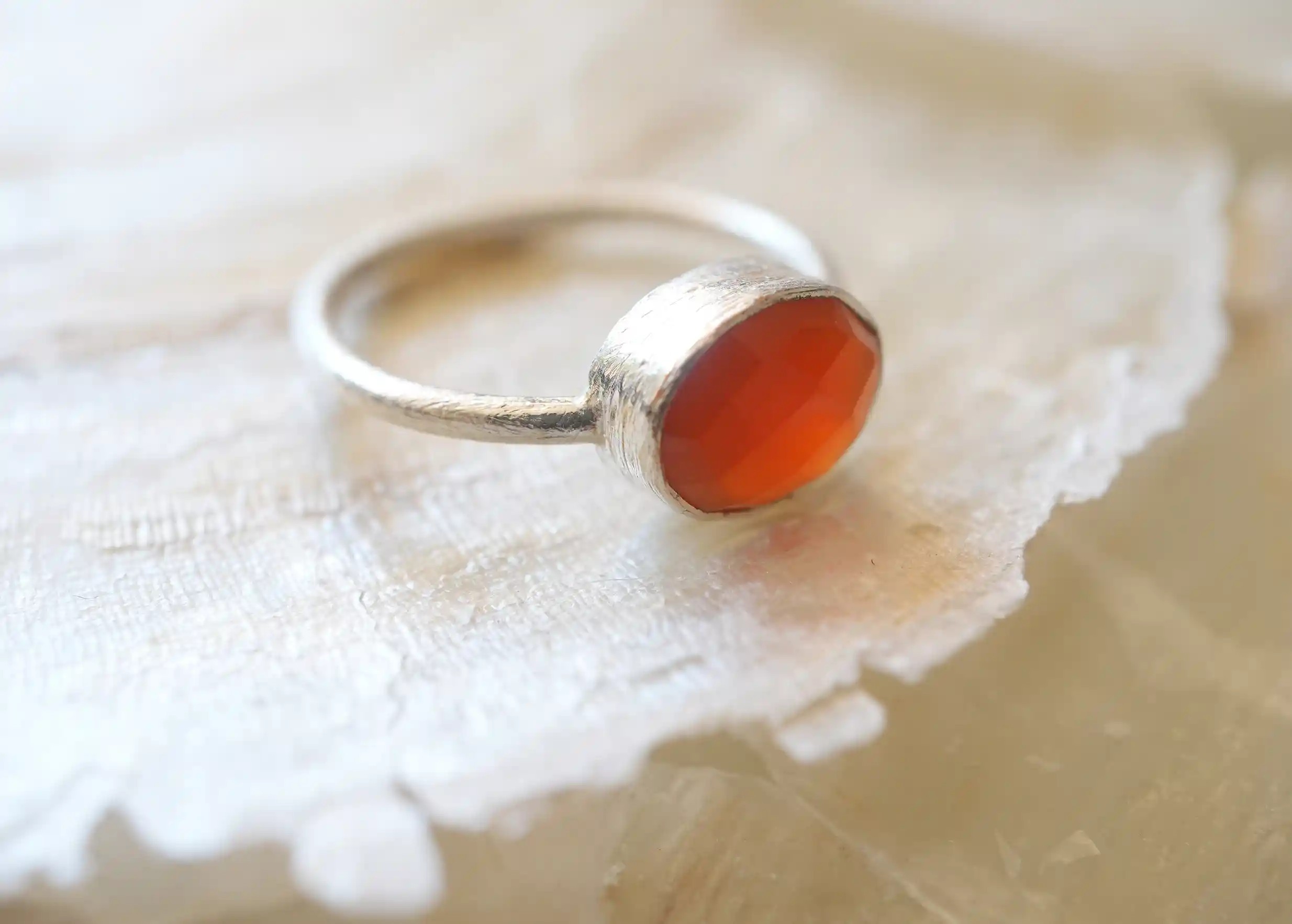 Zoom in on the reflections of the ‘Drop’ ring in silver and carnelian stone, from the Yamuna collection.