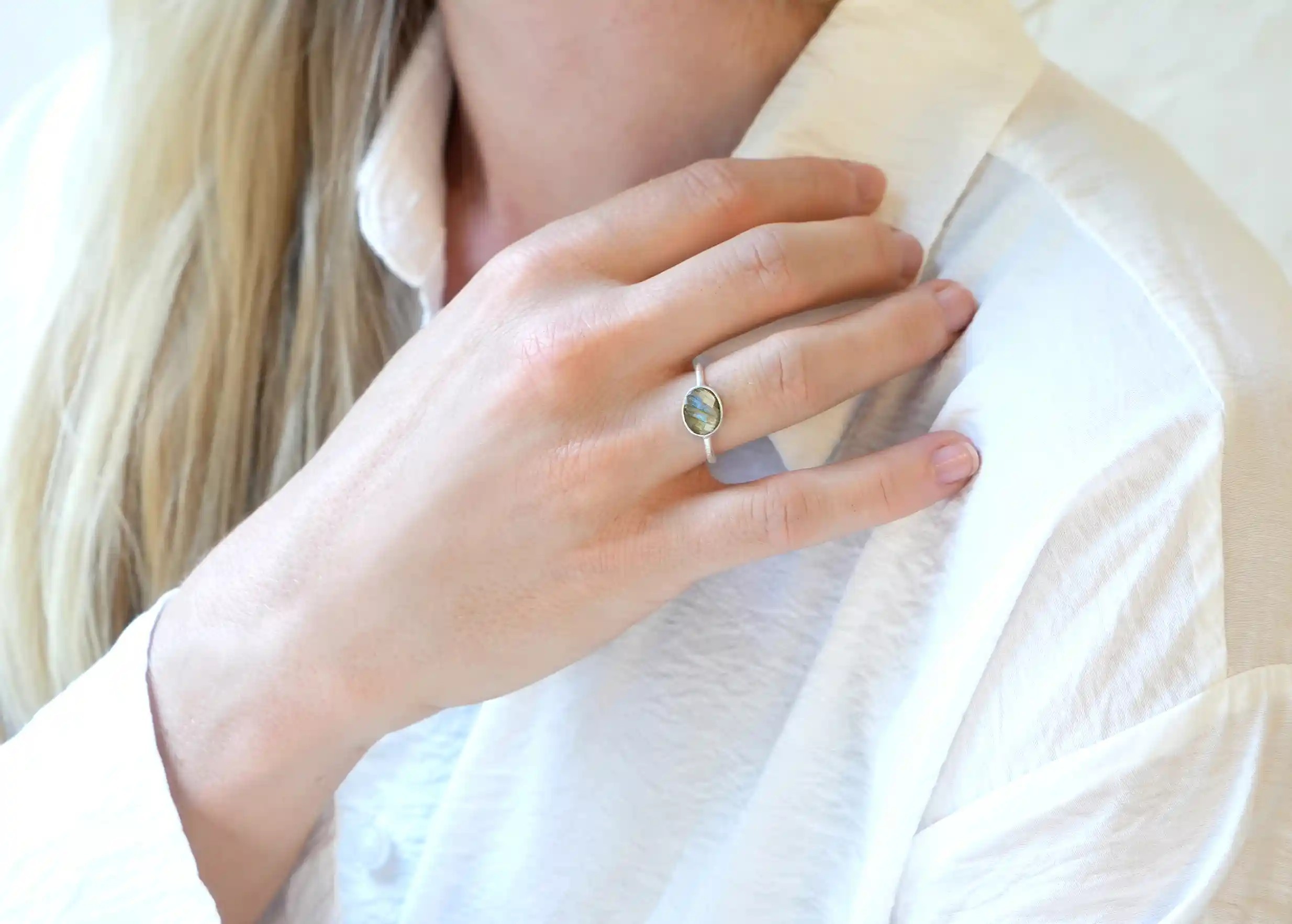 Woman wearing a silver and labradorite stone ‘Drop’ ring, Yamuna collection