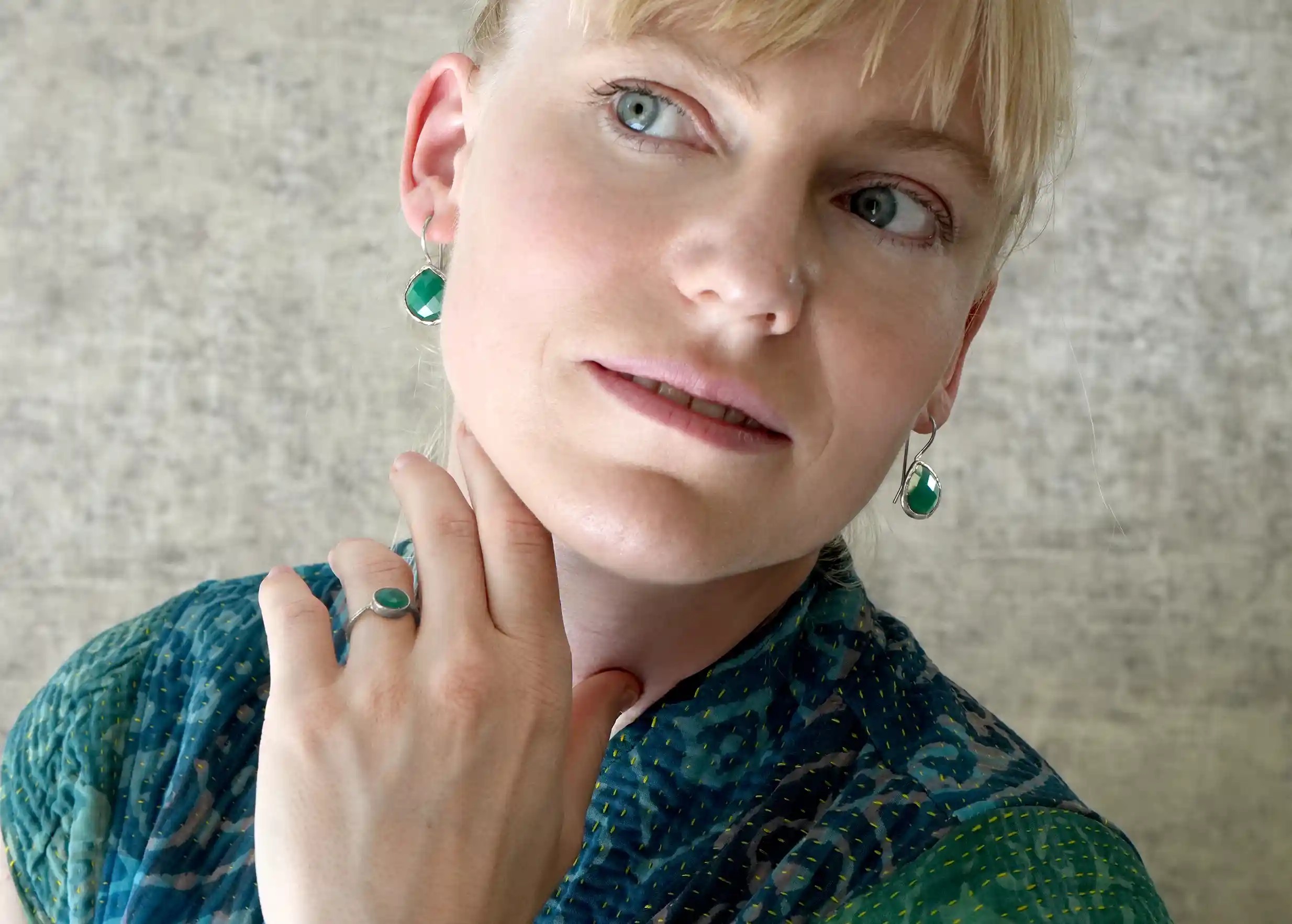 Woman wearing silver and green onyx drop earrings, Yamuna collection