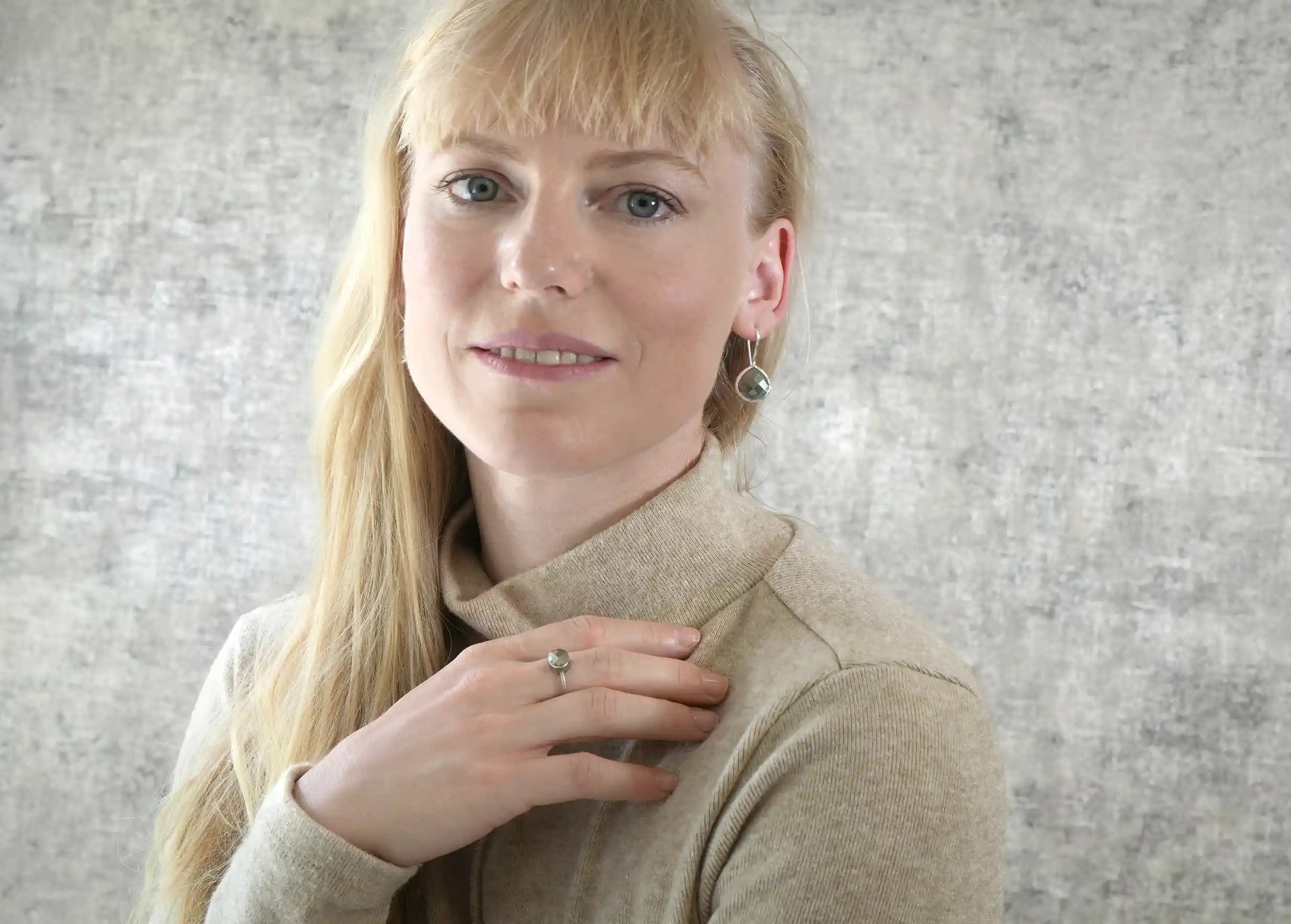 Femme portant bague et boucles d’oreilles « Drop » argent & pierre pyrite, collection Yamuna