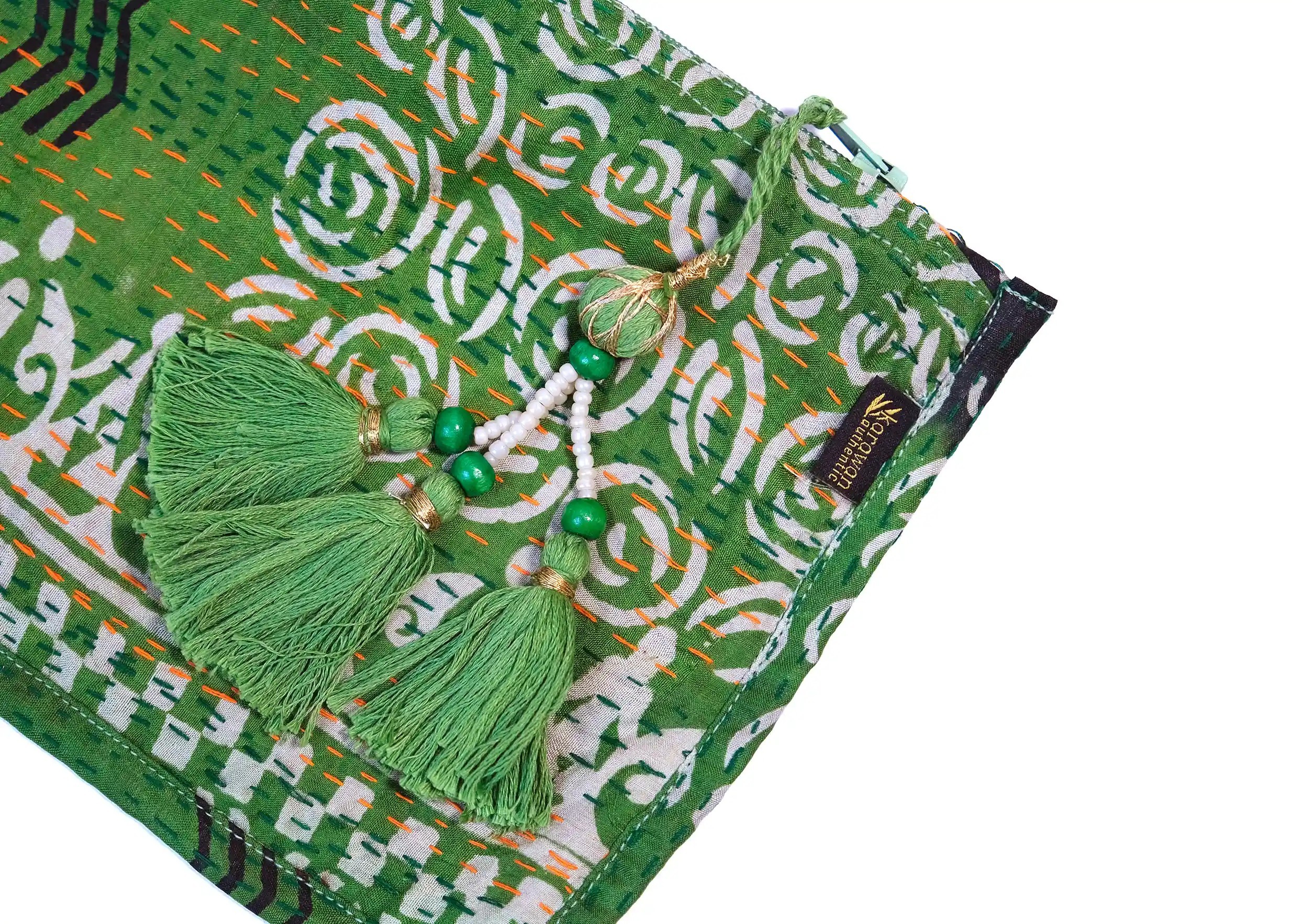 Focus on the details and pompom of the handmade recycled kanta silk pouch, model no. 02.