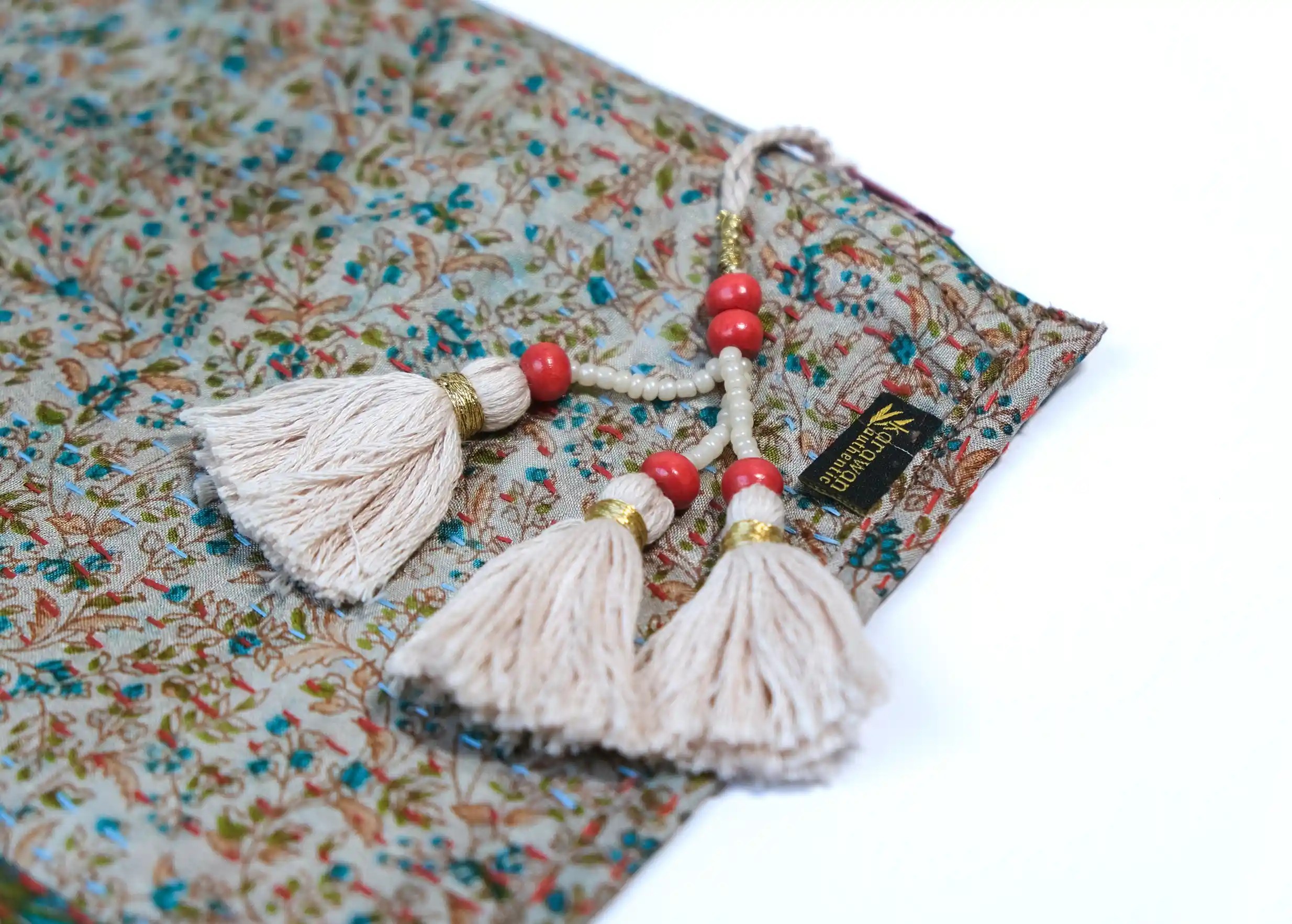 Focus on the details and pompom of the handmade recycled kanta silk pouch, model no. 07.