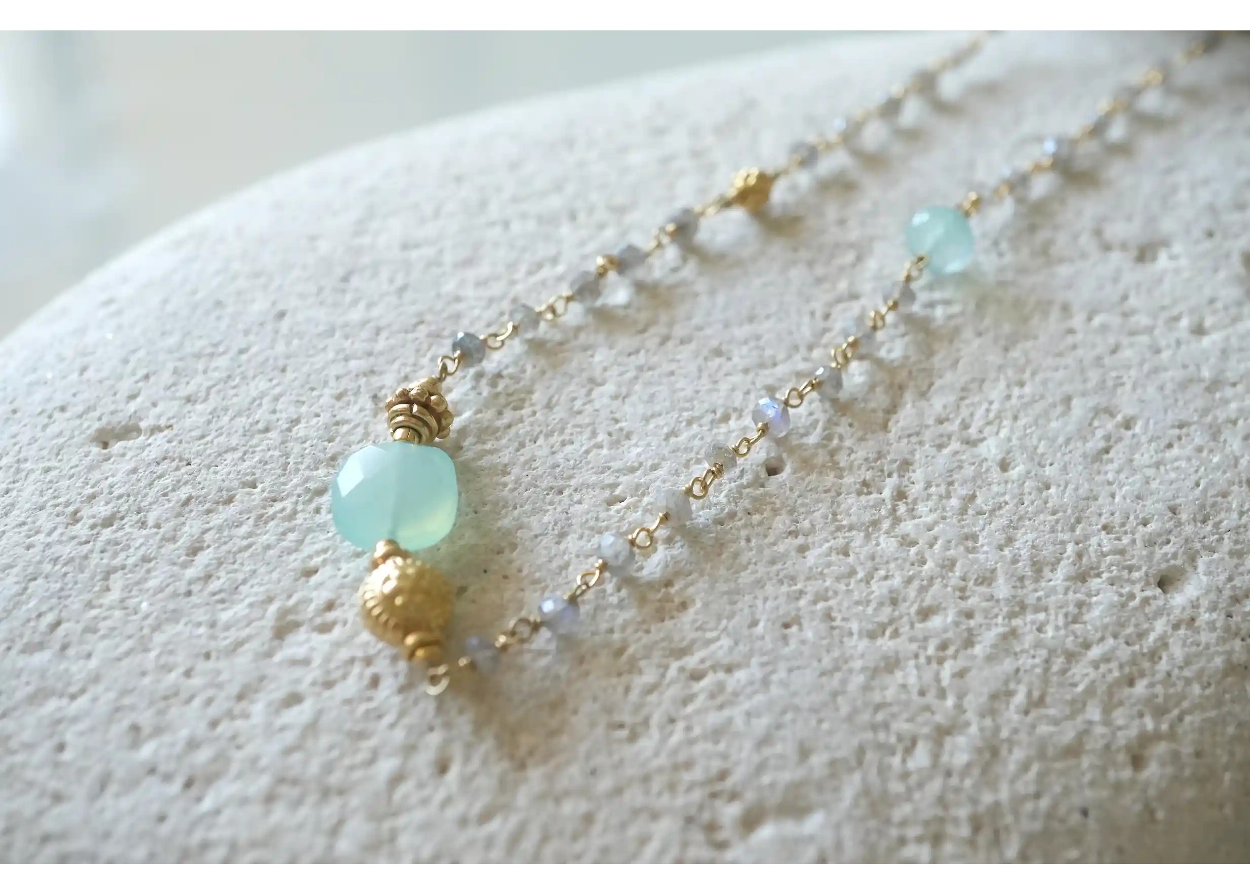 Focus on the stones of the ‘Ani’ gold-plated necklace & aqua chalcy and labradorite stones, Yamuna collection