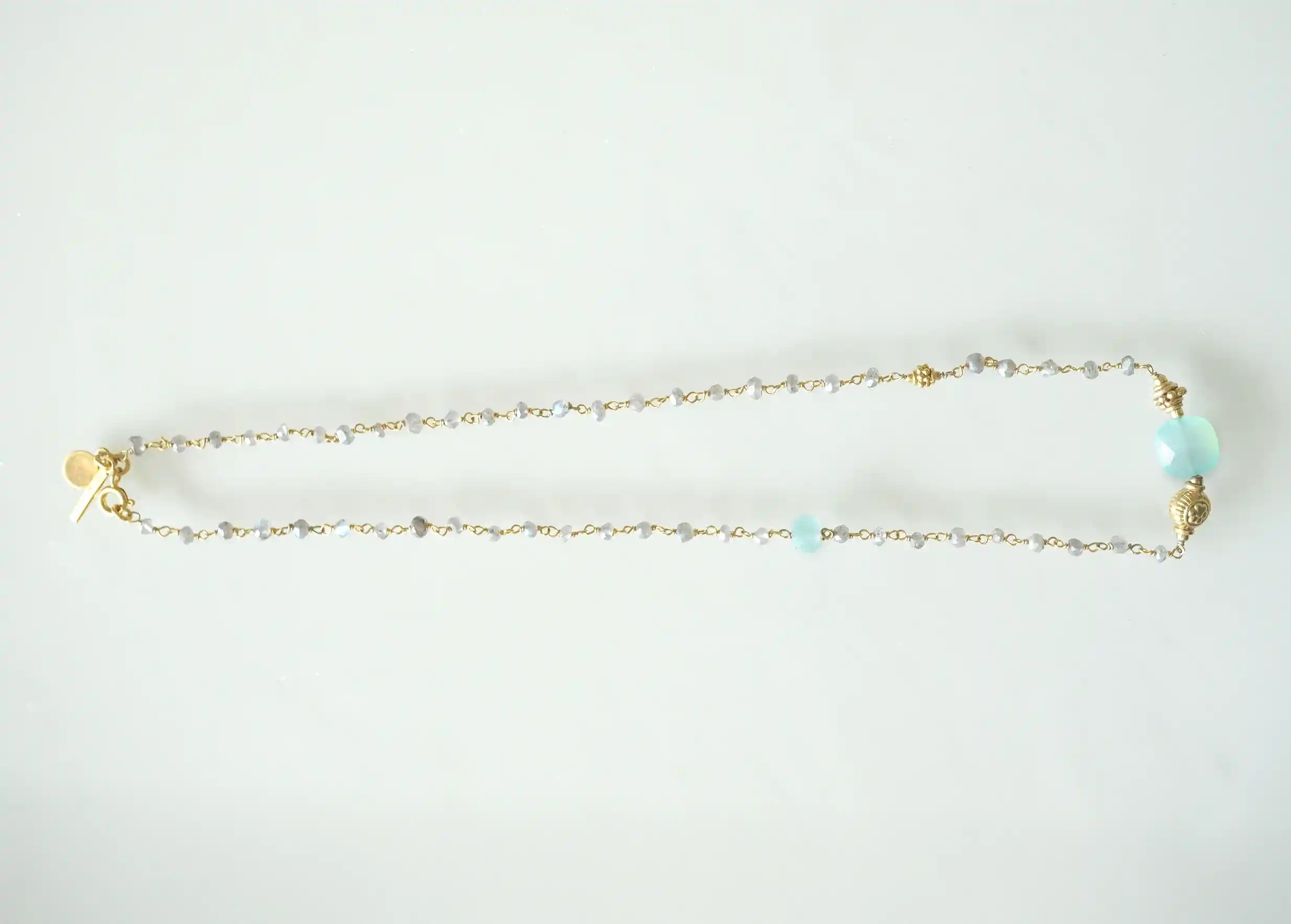 ‘Ani’ gold-plated necklace with chalcedony and labradorite stones, photo taken against a white background