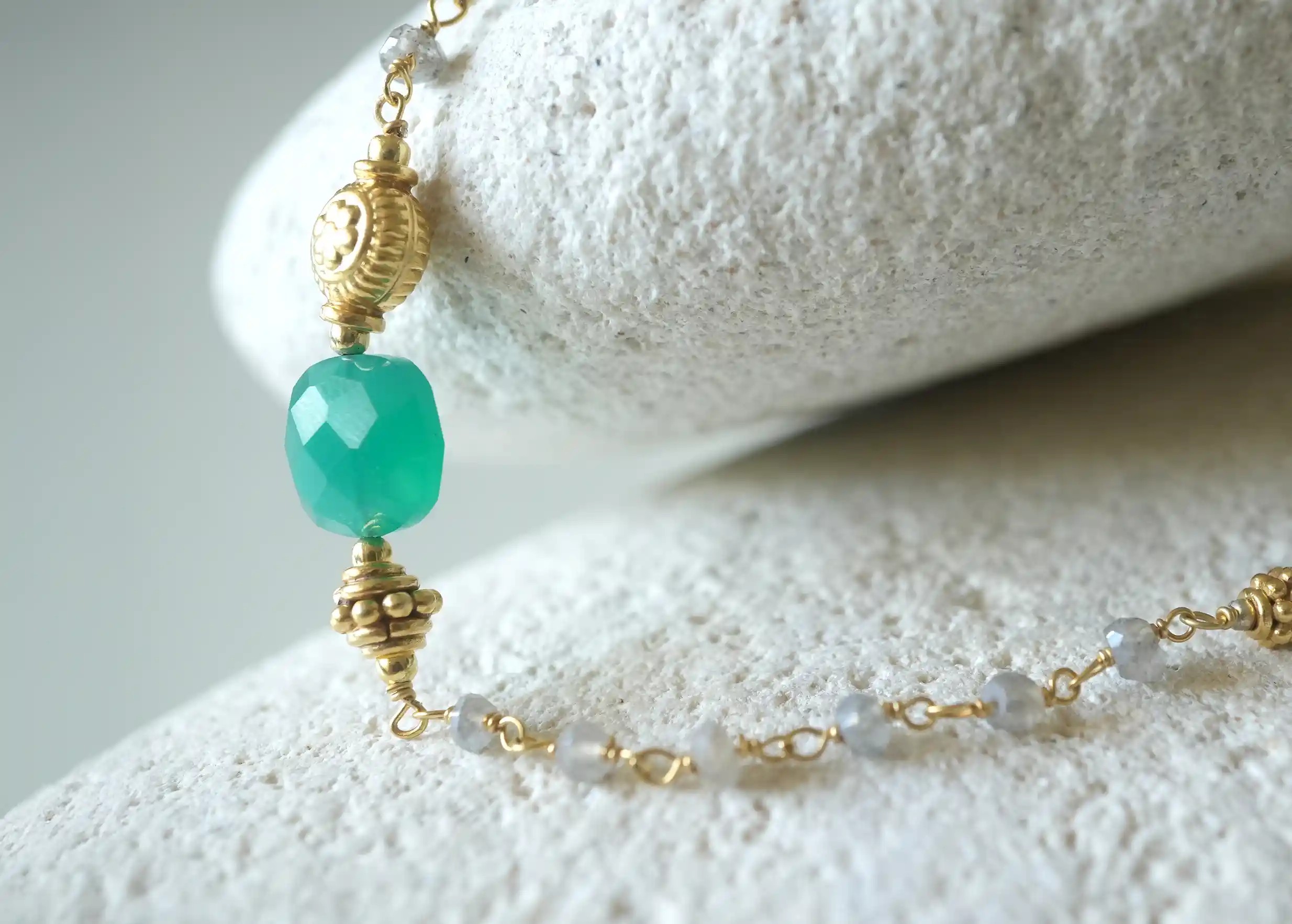Focus on the stones in the ‘Ani’ gold-plated necklace & green onyx and labradorite stones, Yamuna collection