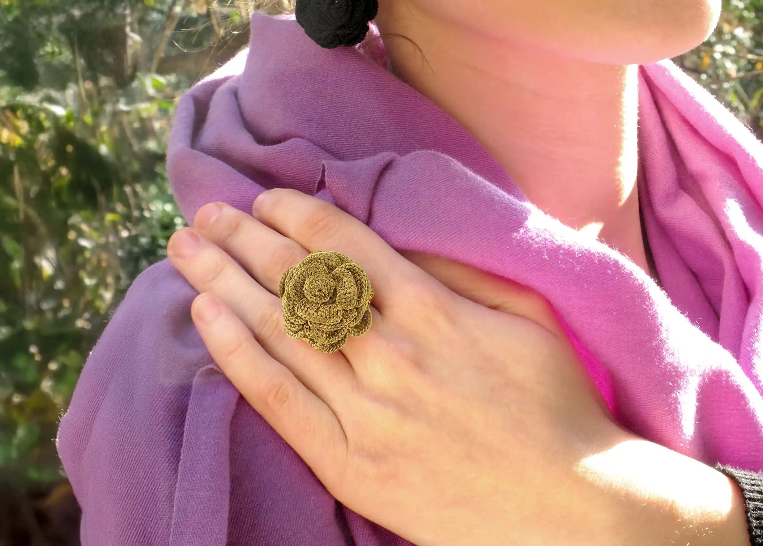 Woman outdoors wearing a Belkis lace ring in aniseed colour