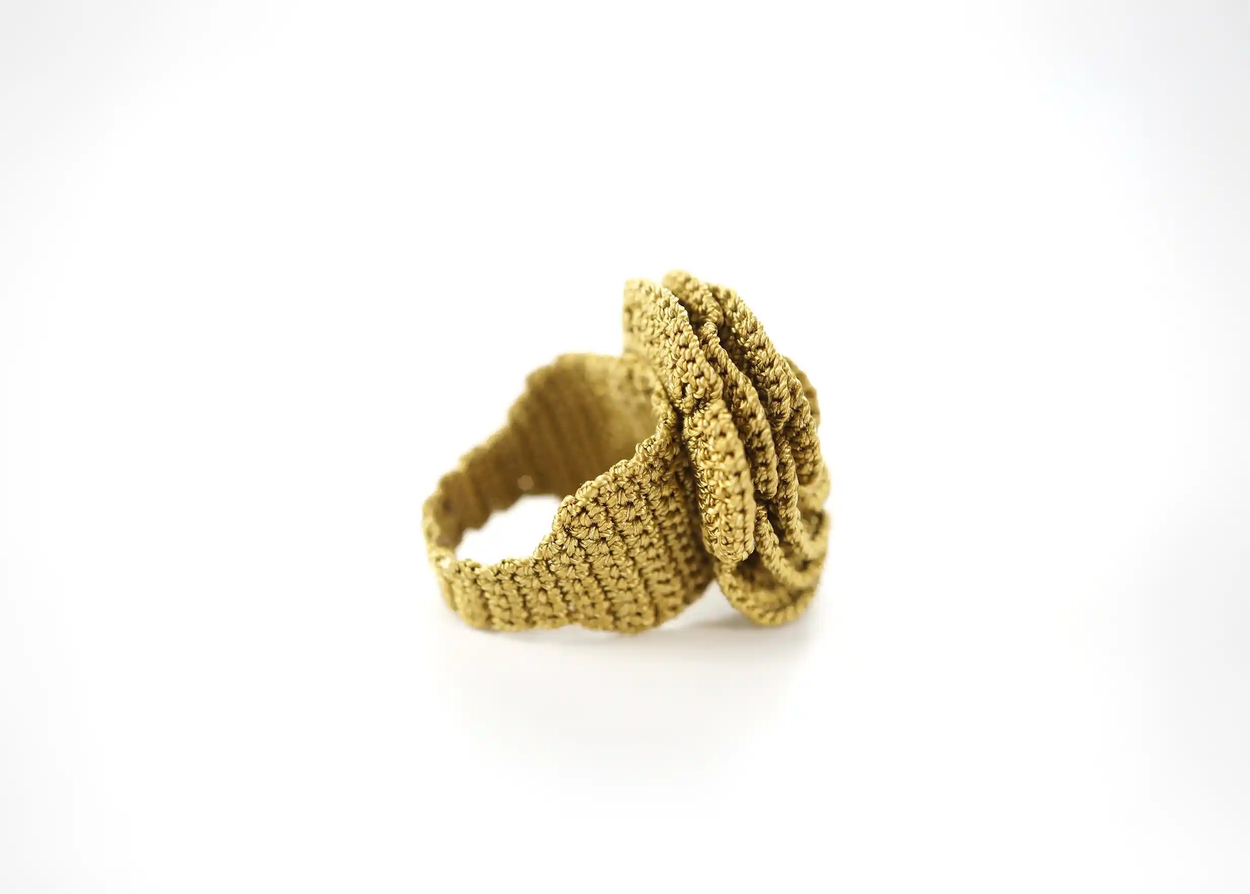 Anise-coloured lace ring, side view on white background