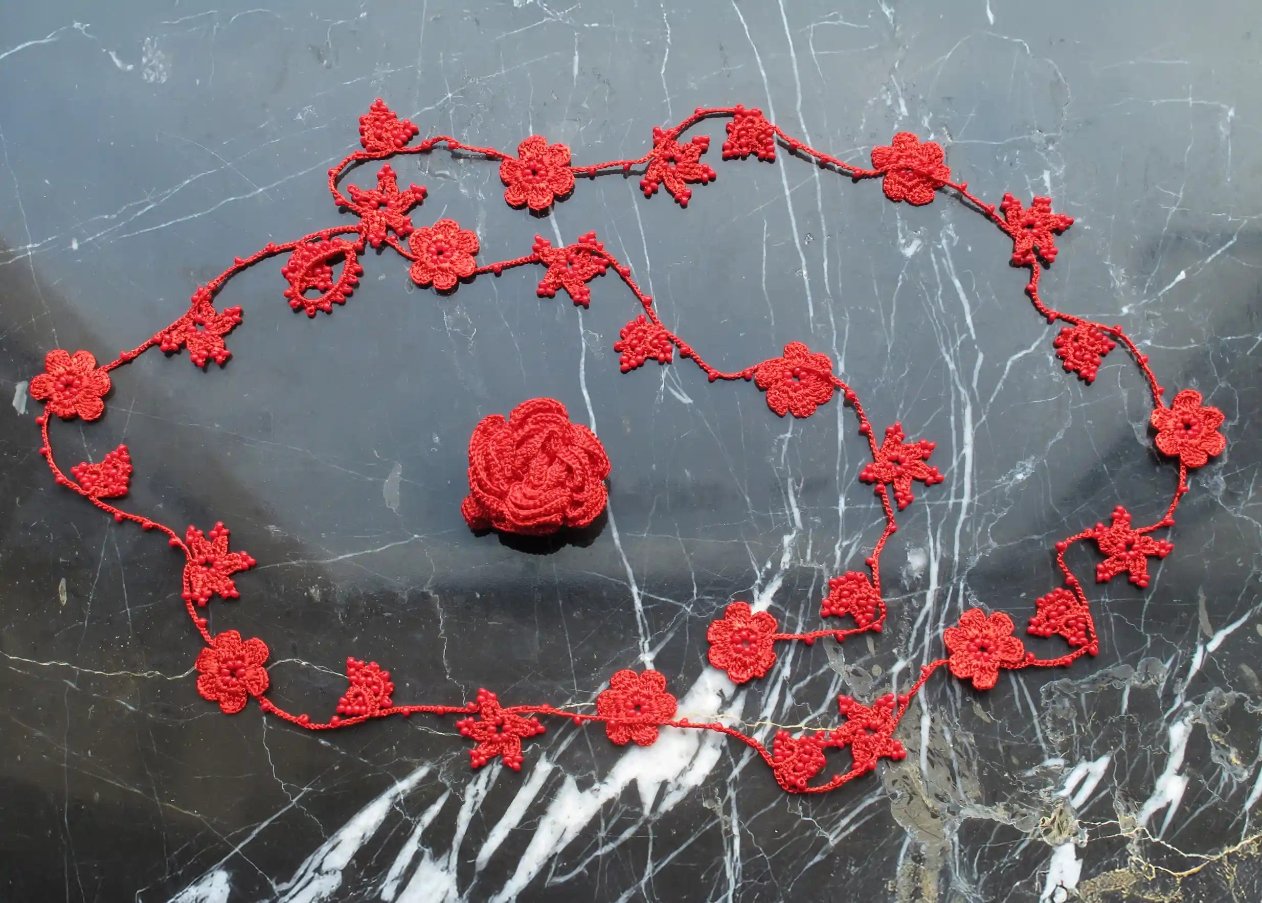Floral design on red lace ring and necklace