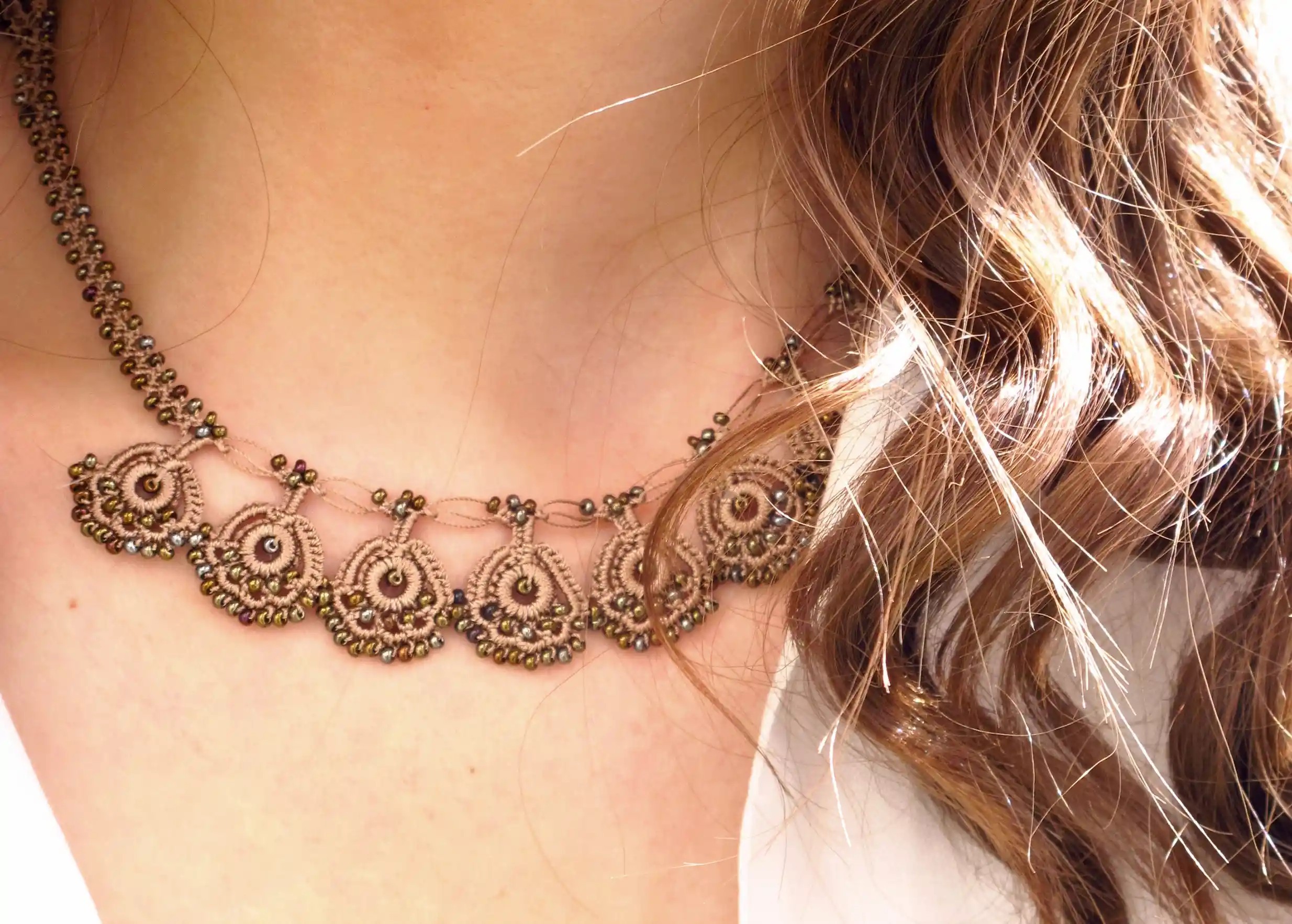 Eda lace necklace, golden sand colour, worn around the neck
