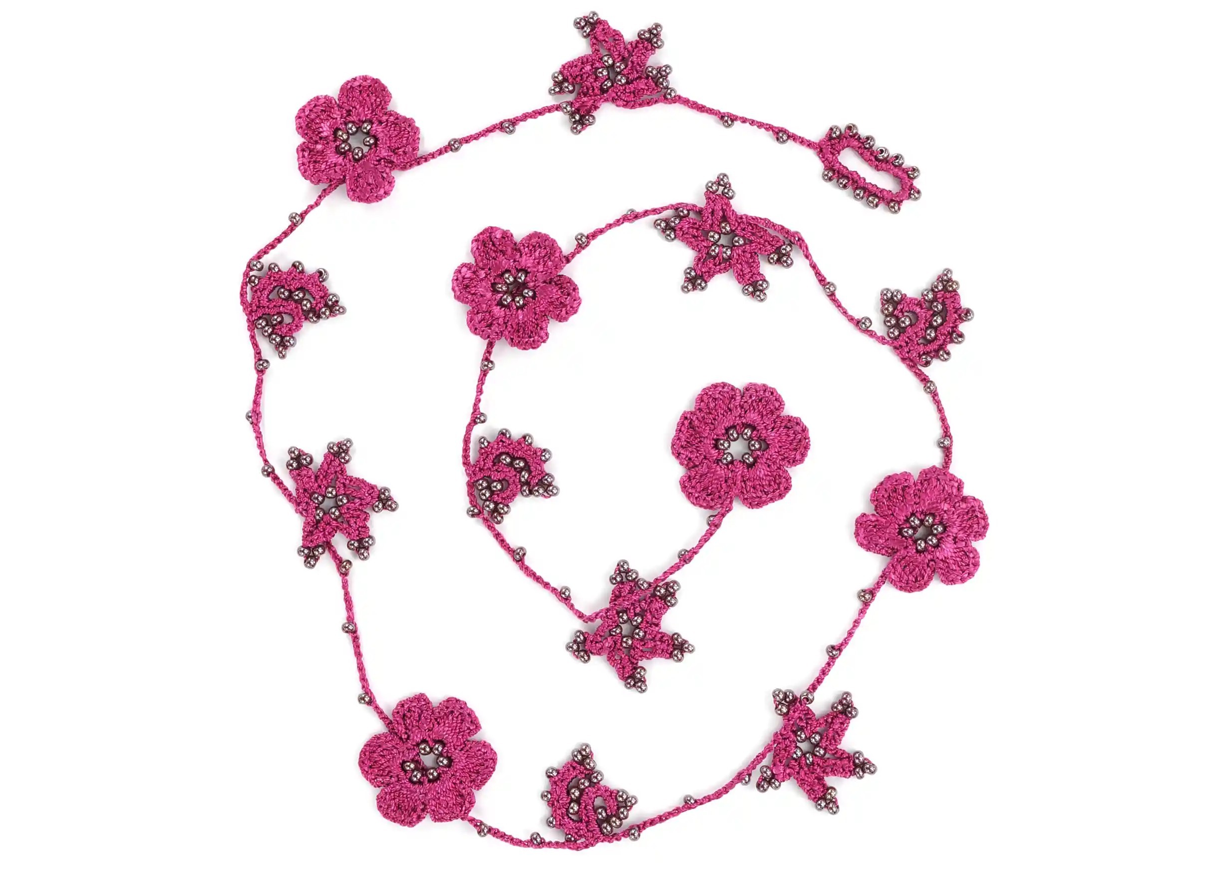 Focus on the design of a bergamot-coloured lace necklace, with decorative threads and motifs adorned with pearls.