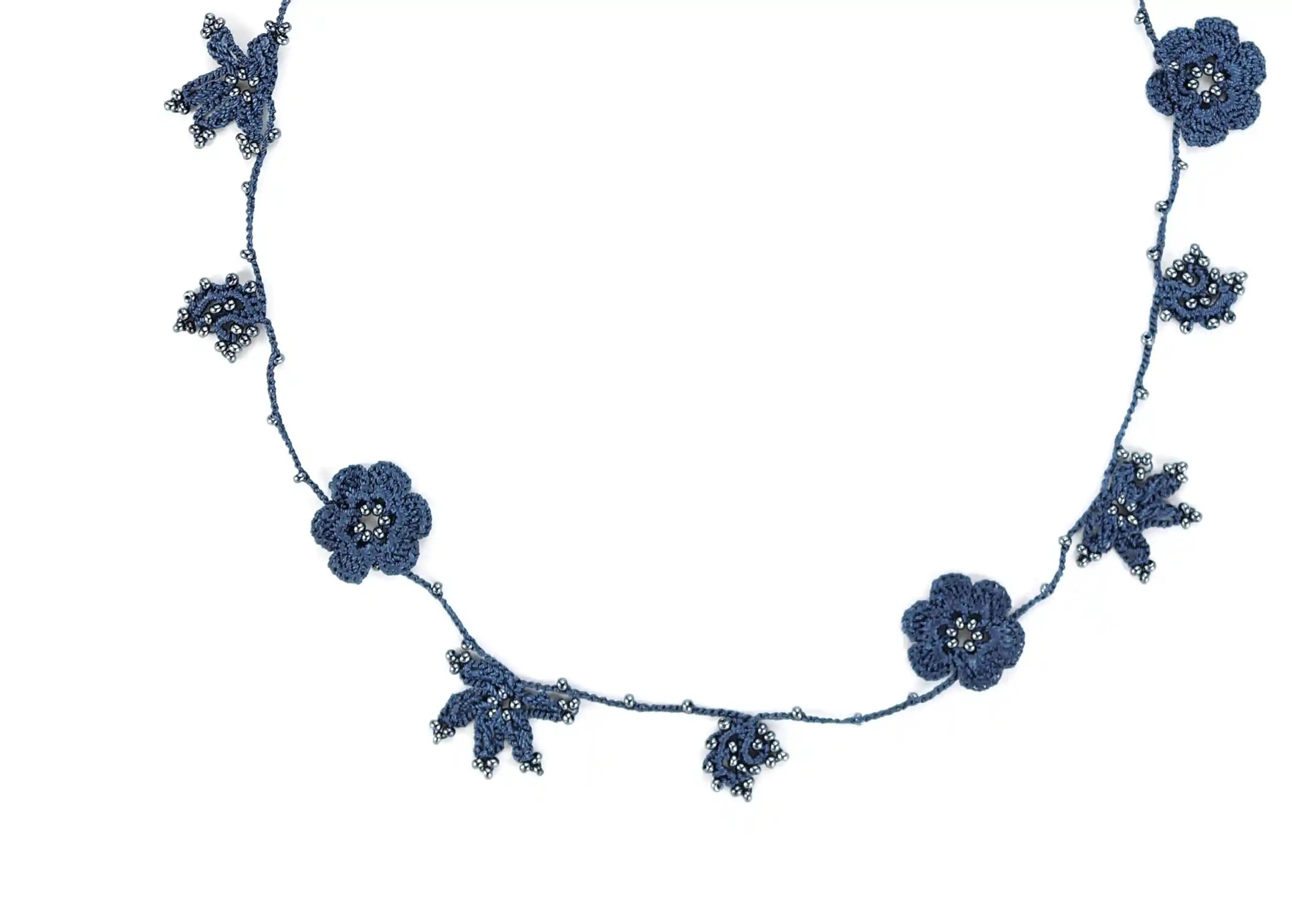 Focus on the design of a midnight blue lace choker, with decorative threads and motifs adorned with pearls.