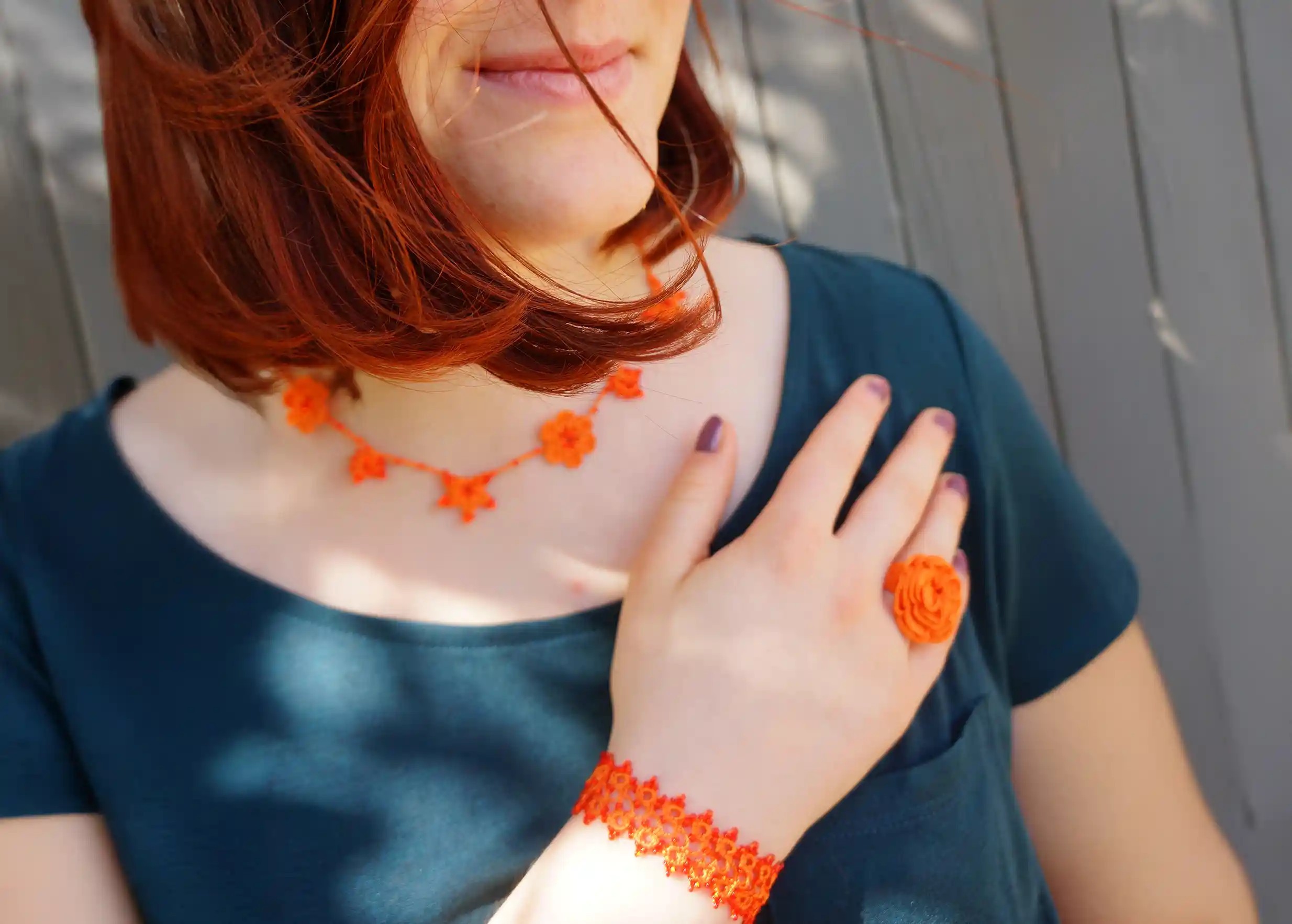 Papaya-coloured Crystal lace choker worn by a woman outdoors