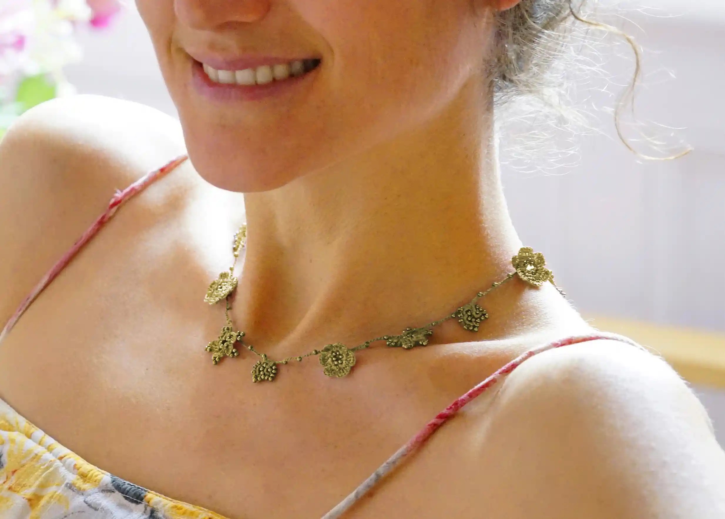 Crystal lace choker in lichen green, worn around the neck