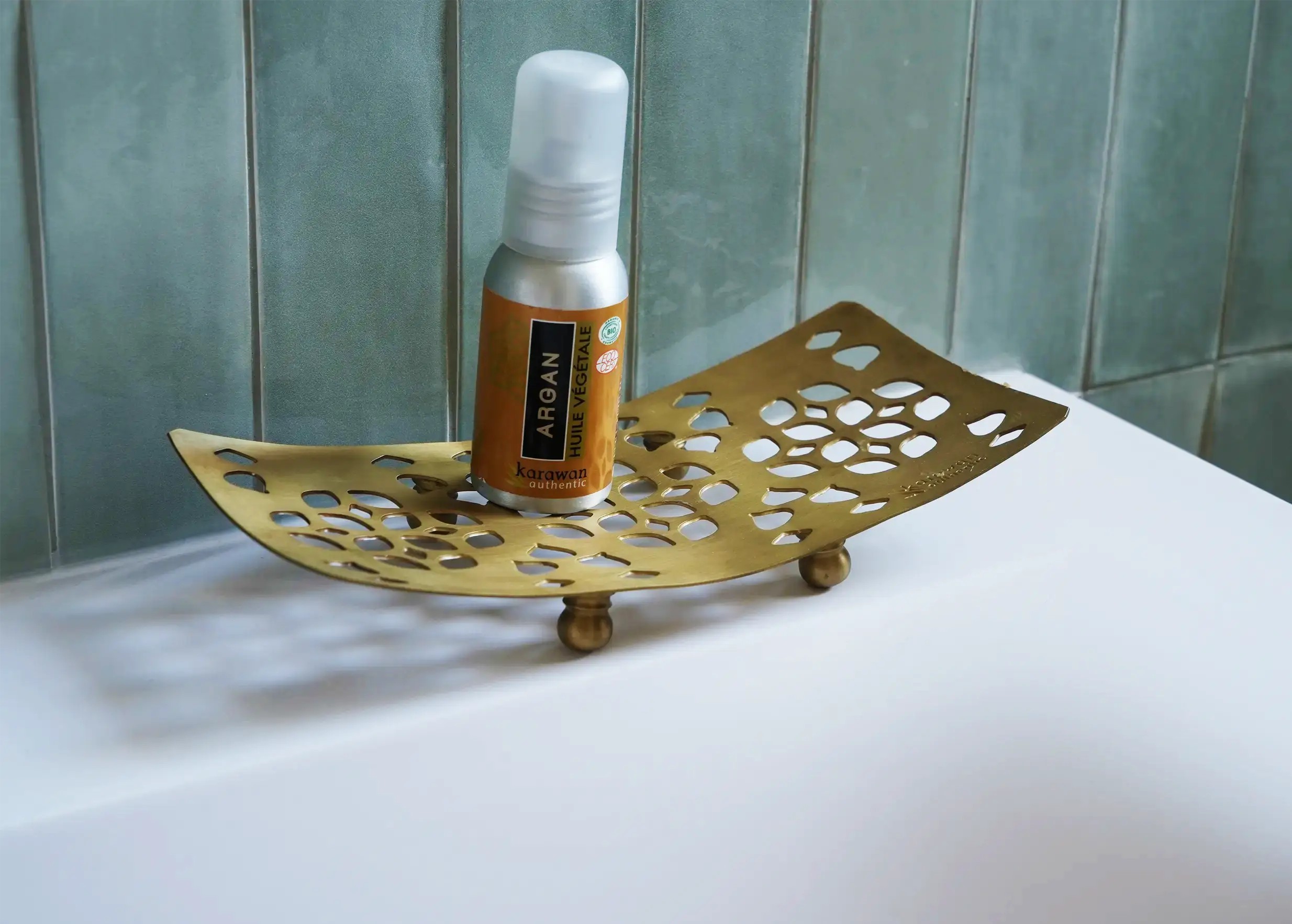 Brass bathroom accessory holder with argan oil, Naïri model by Karawan
