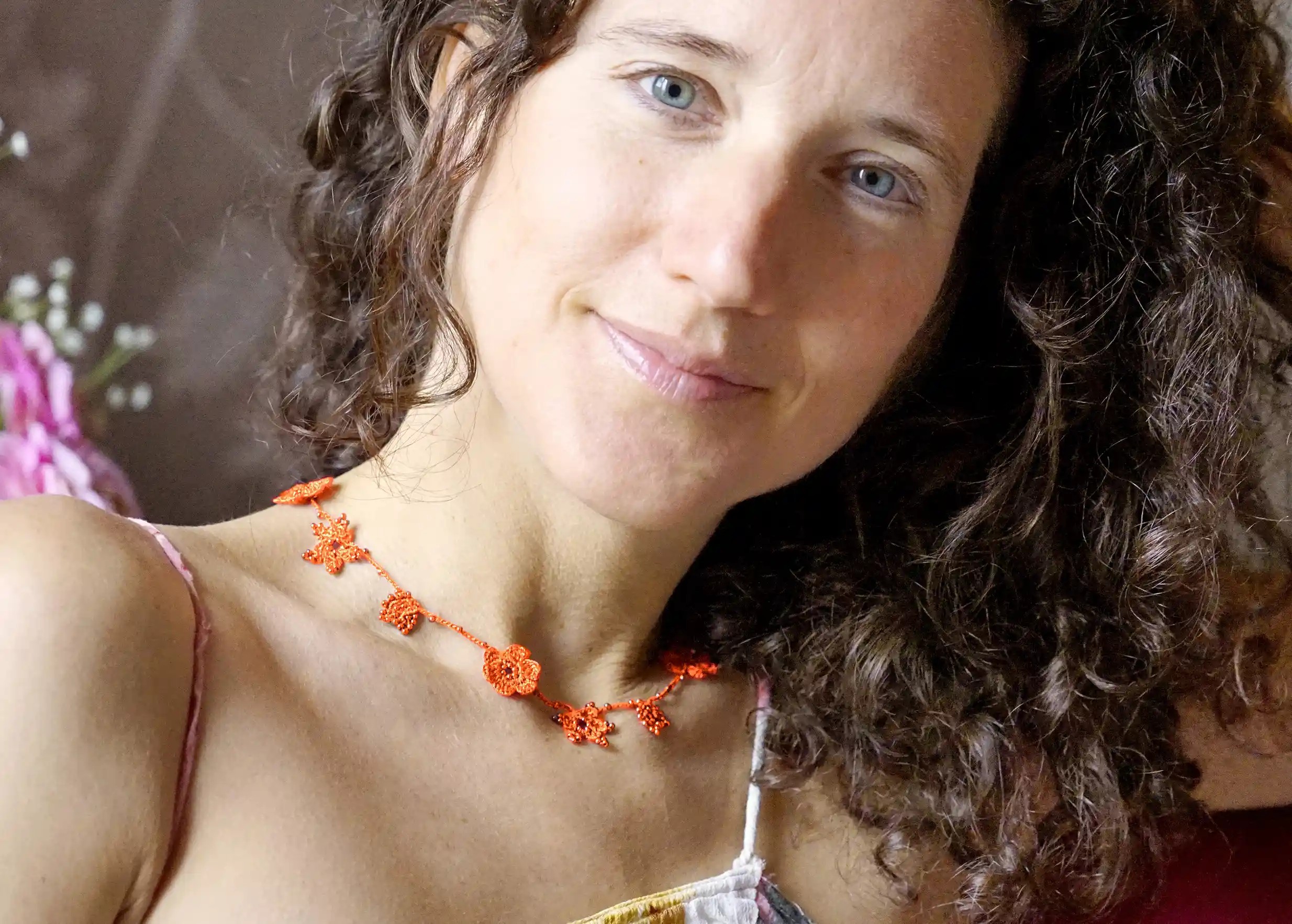 Papaya-coloured Crystal lace choker, worn around the neck