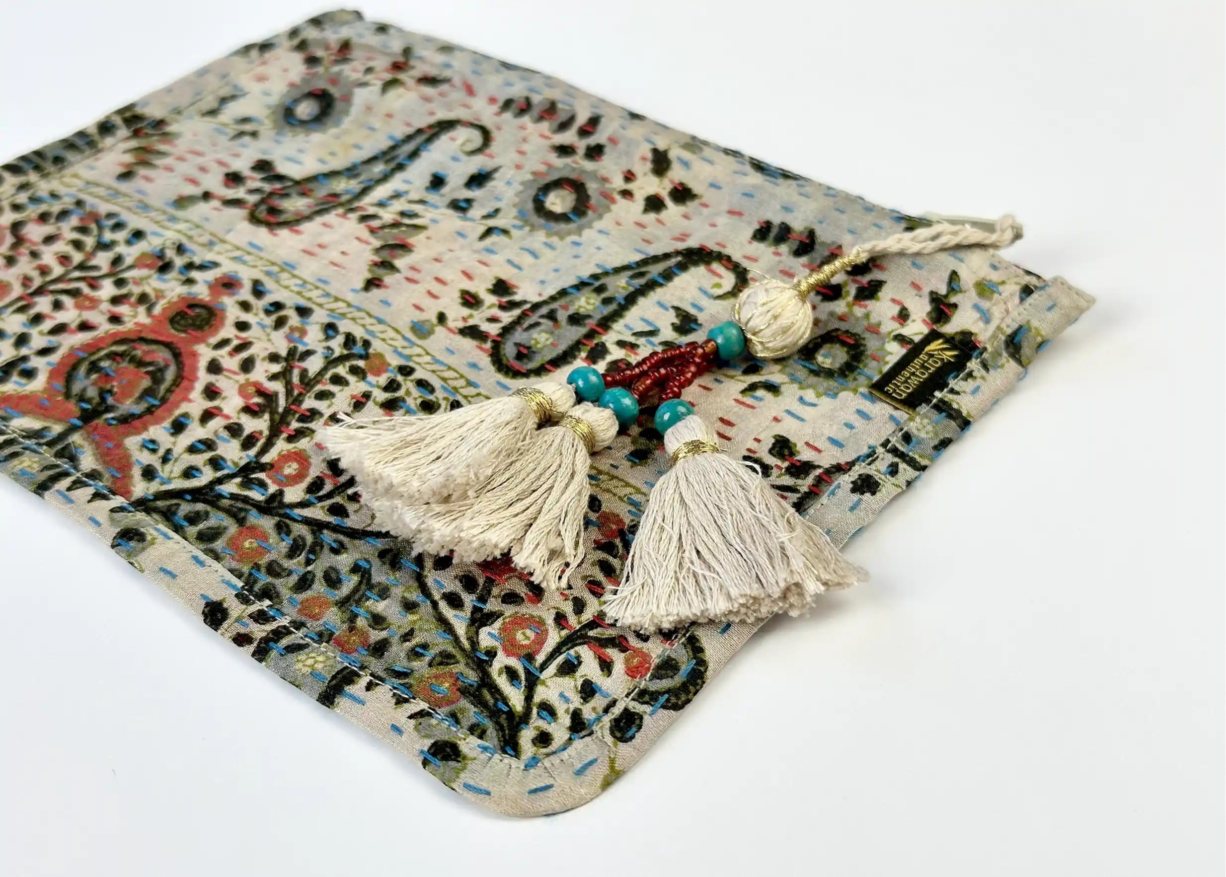 Focus on the pompom and patterns of the handmade recycled kanta silk clutch bag, model no. 05