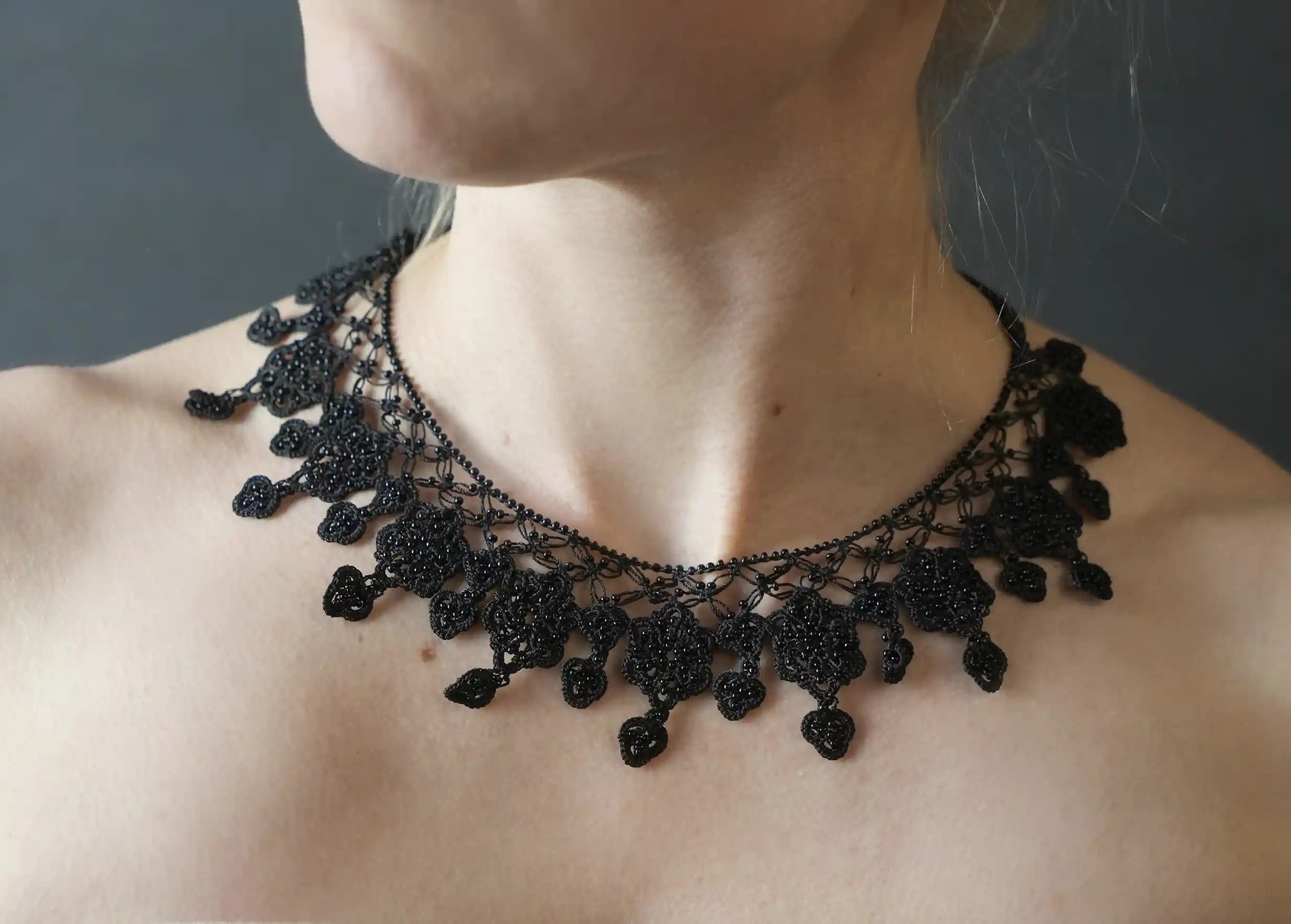 Close-up of the Sonya necklace in black, worn