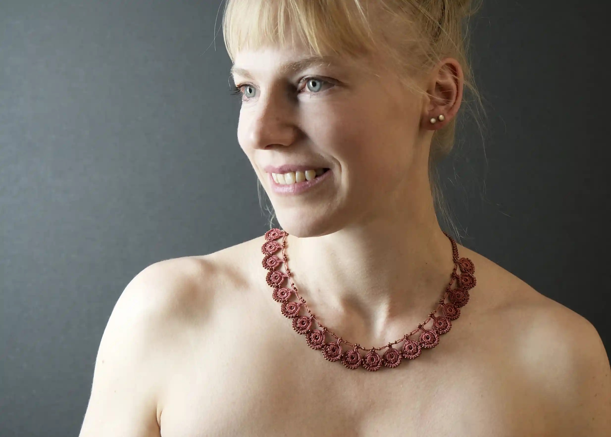 Karawan brand matte copper Eda necklace worn by a woman