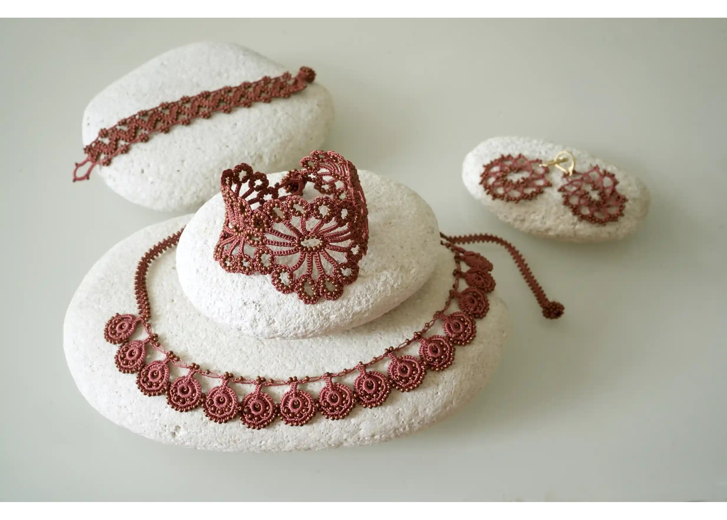 Assortment of several models from the Oya jewellery collection in matt copper colours