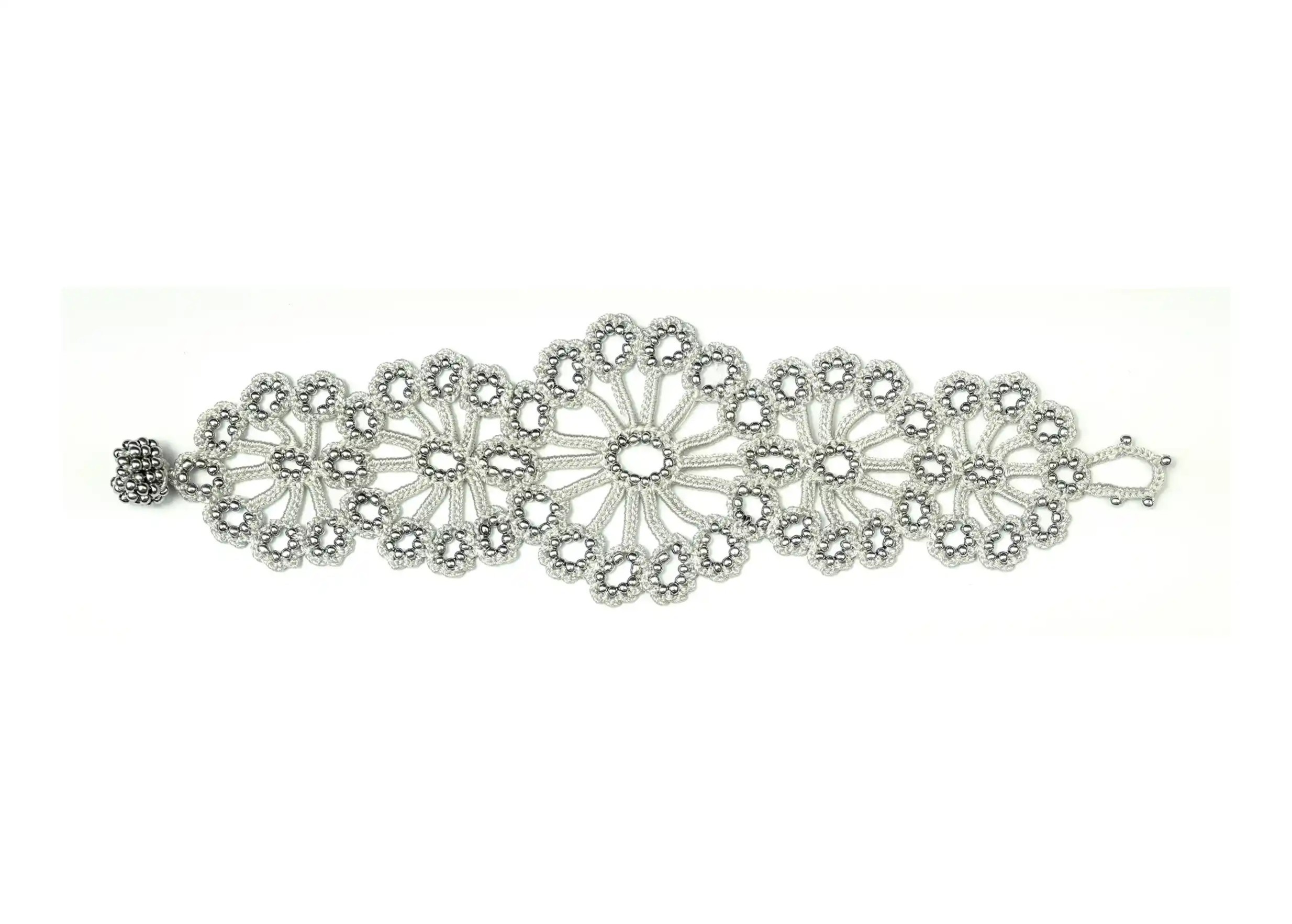 Silver grey Hawa lace bracelet, decorated with pearls, white cut-out background