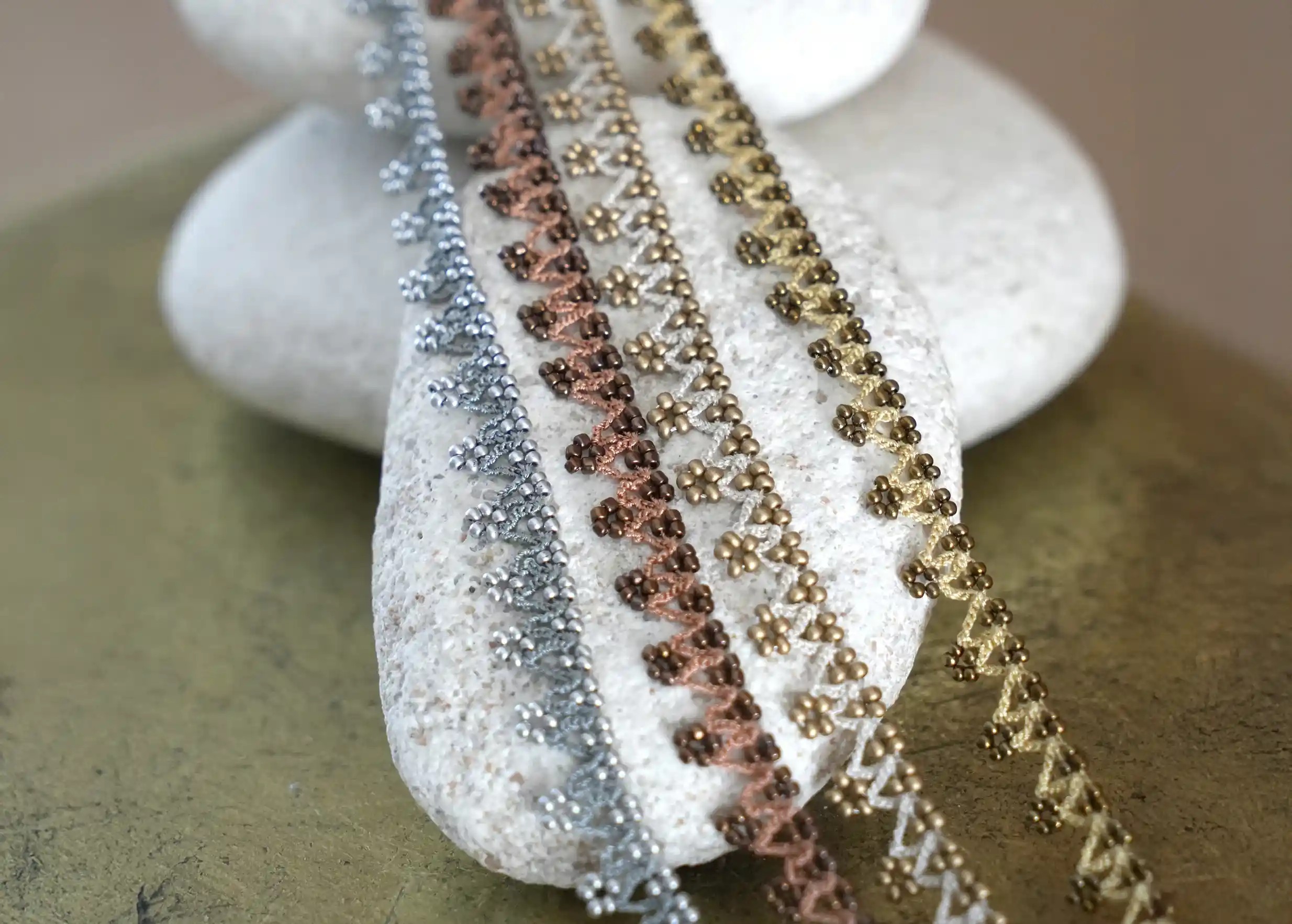 Trio of lace necklaces in different colours, from the Karawan Authentic brand