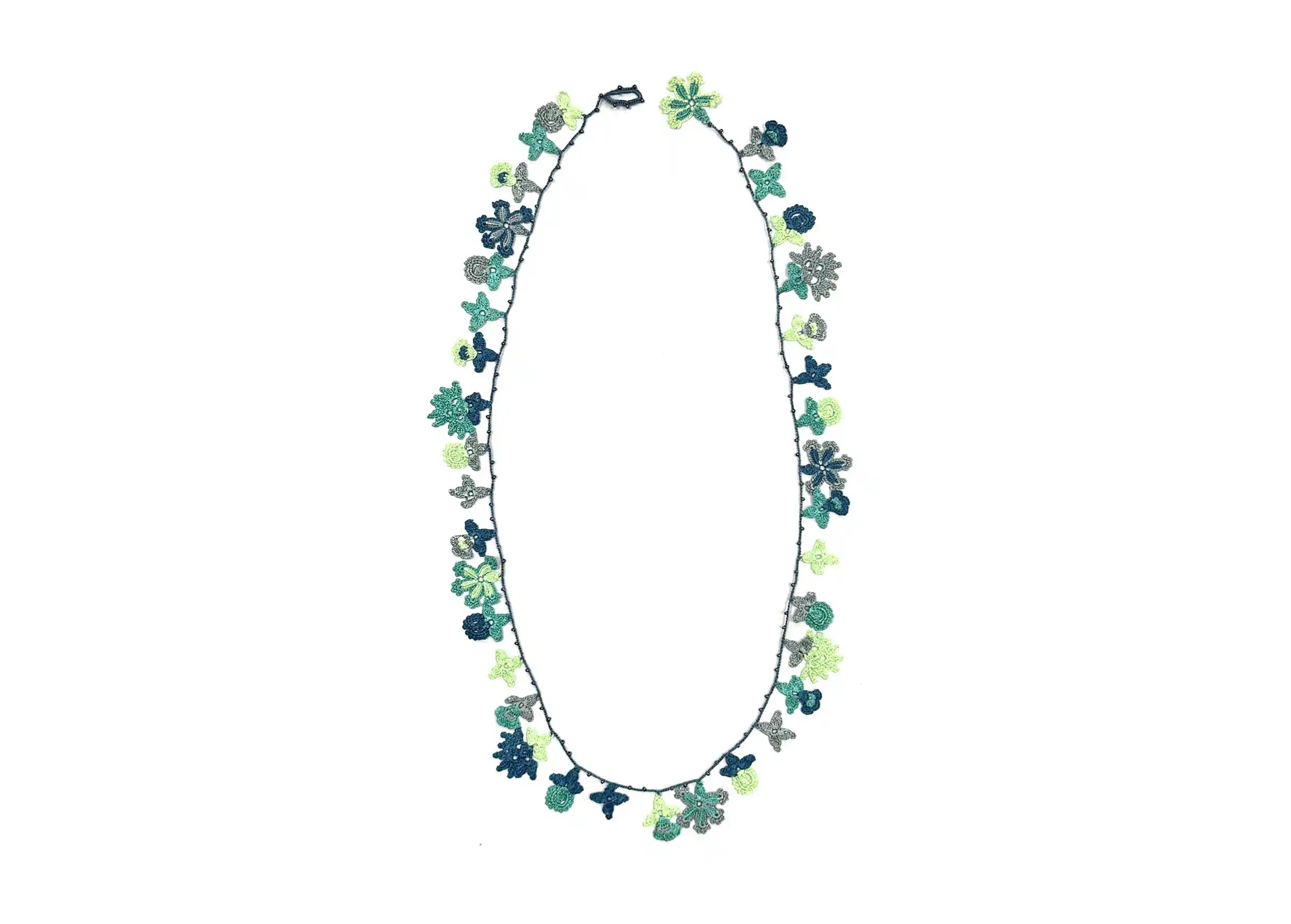 Bloom ocean-coloured lace necklace by Karawan, photo taken against a white background