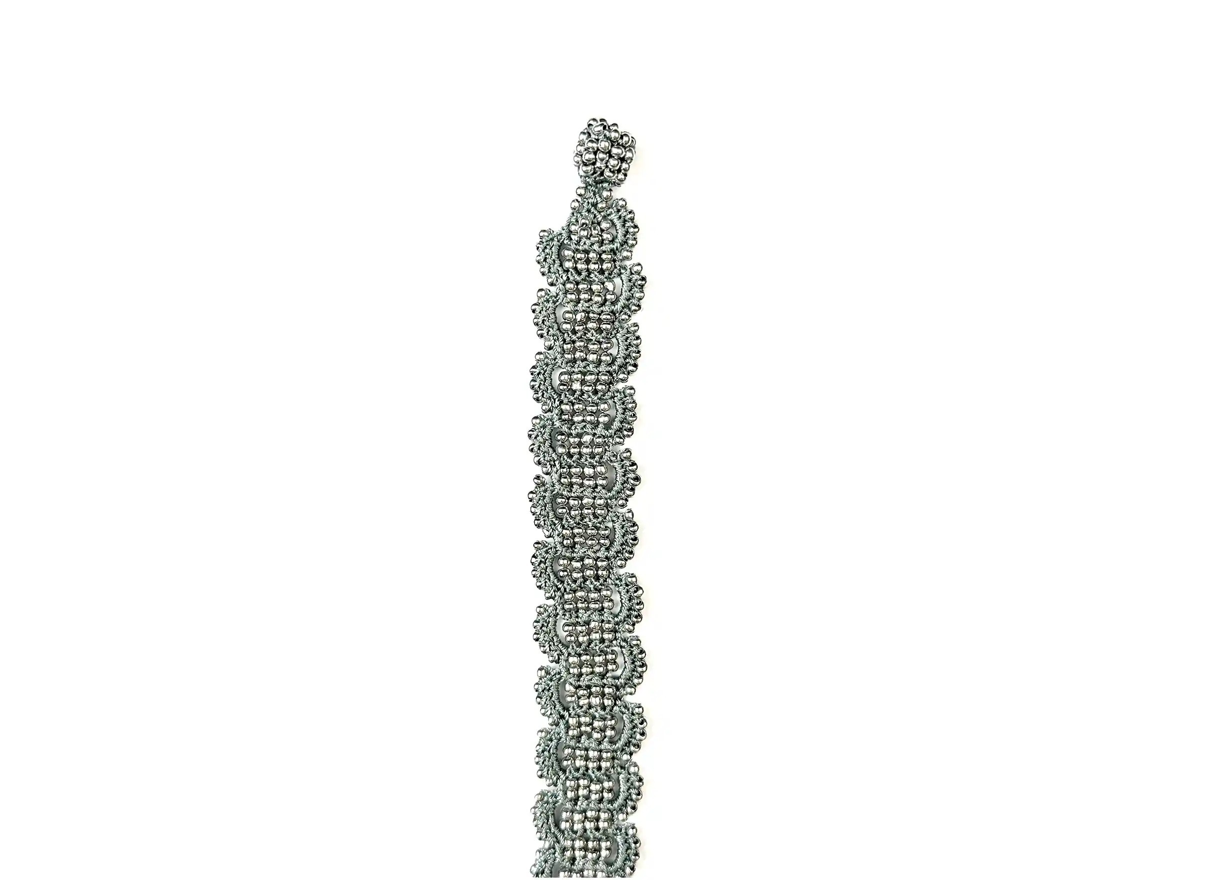 Bracelet made of thread and pearls in glacier blue and silver, Bark model, photo taken against a white background