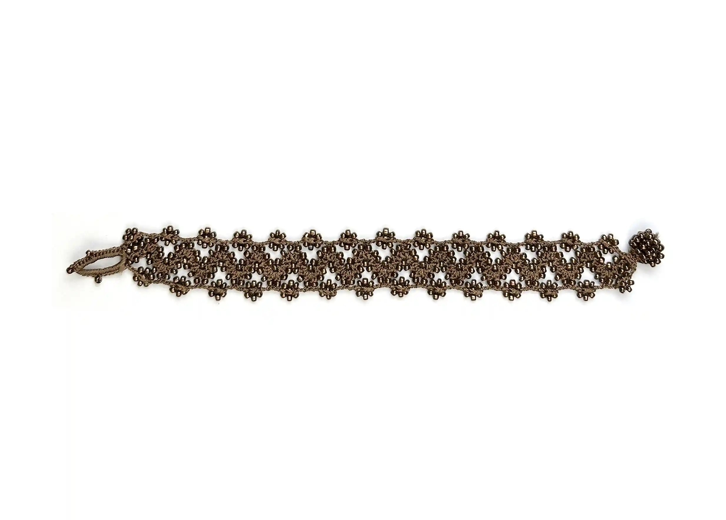 Textile bracelet made of thread and beads, Ribbon model in amber brown, photo taken against a white background