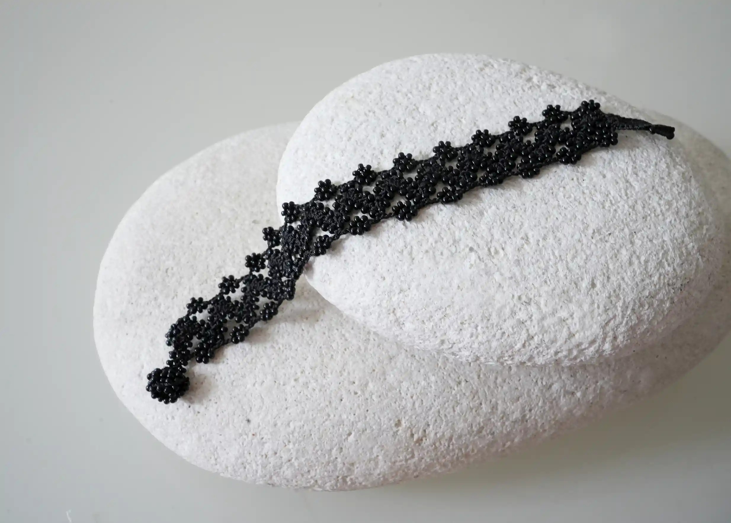 Textile bracelet made of thread and beads, with graphic patterns, Ribbon model in black