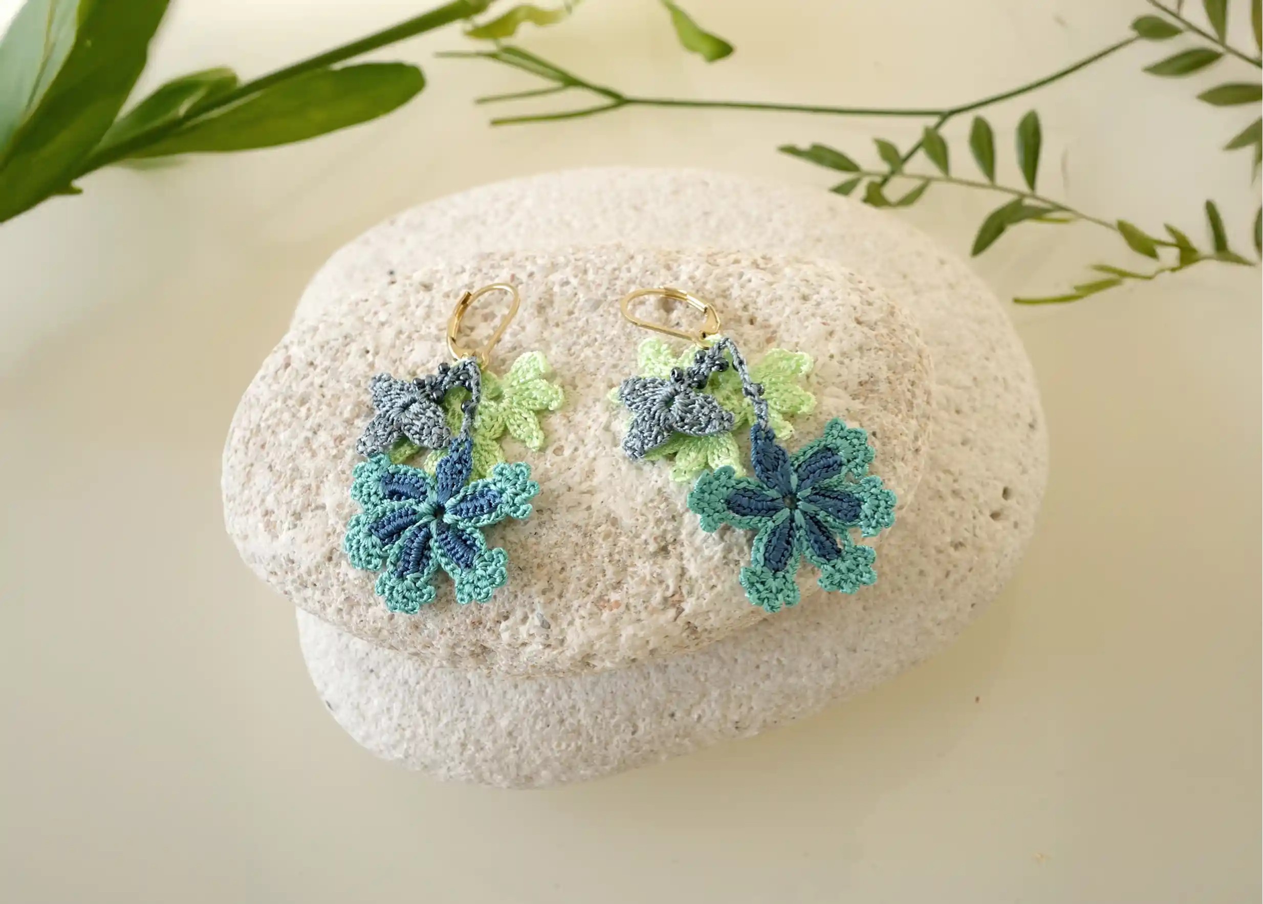 Thread lace and pearl earrings, ocean colour, photo taken on pebbles