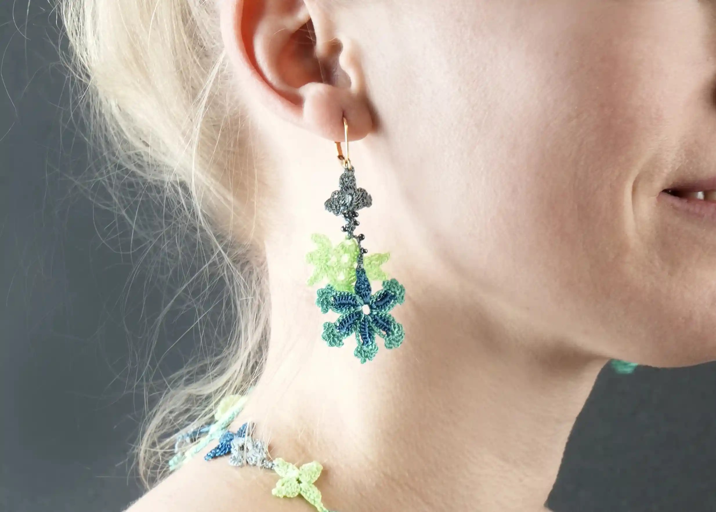 Focus on Bloom lace thread and pearl earrings, ocean colour