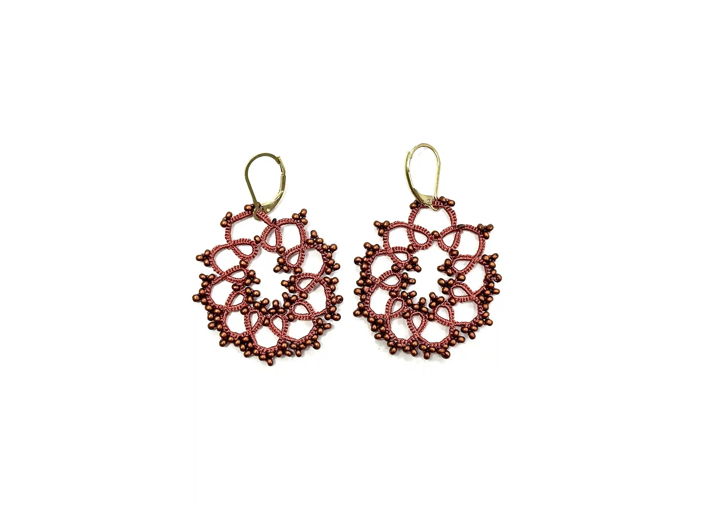 Earrings made from wire and beads, with a geometric pattern, matt copper colour, photo taken against a white background