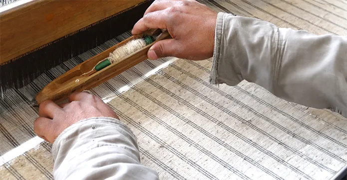 Weaving nettle on a traditional loom